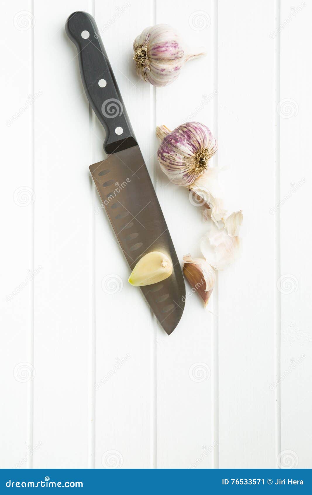 Peeled garlic on knife stock image. Image of food, life 76533571