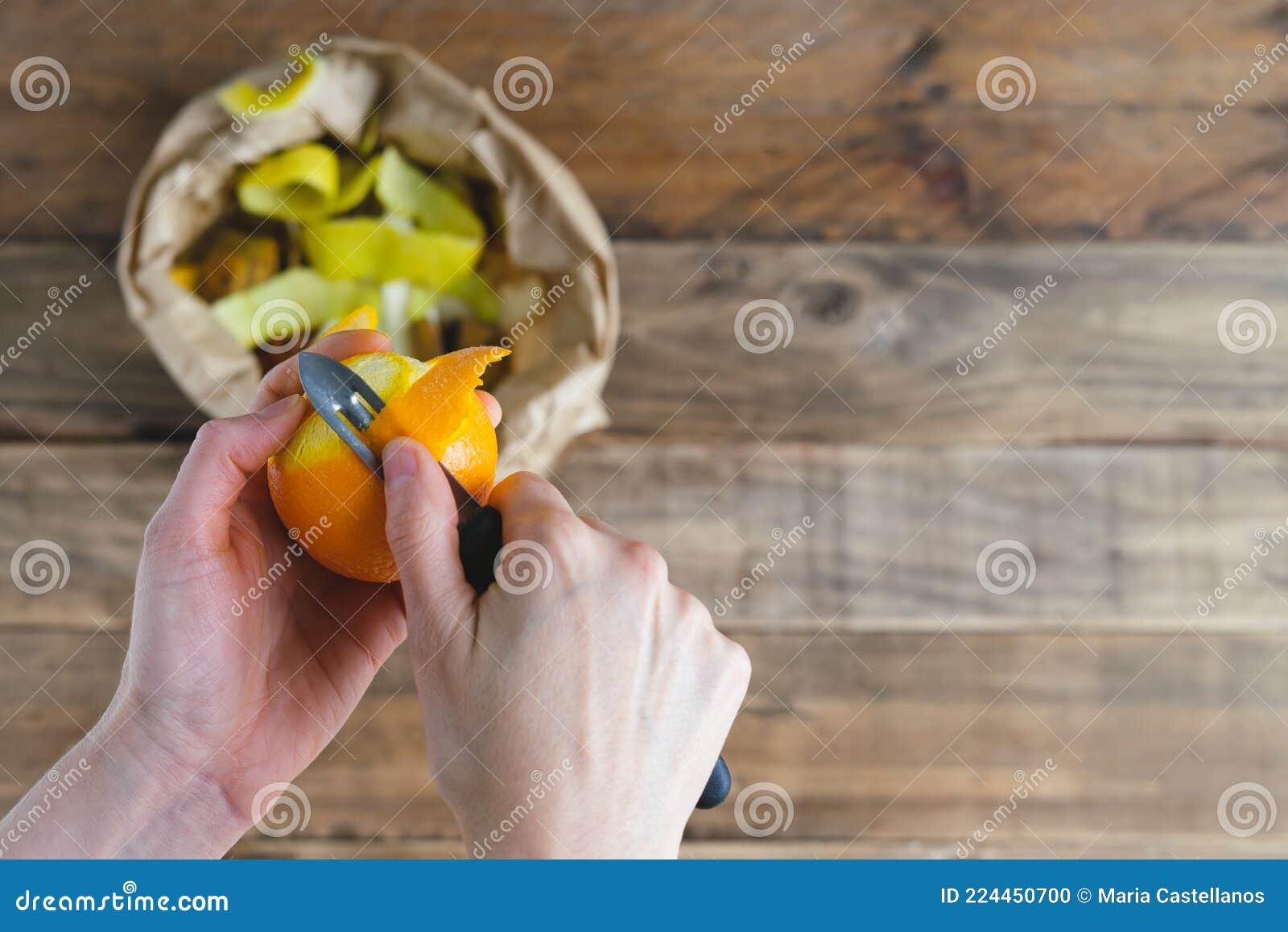 Peeling Orange and Bag of Peels for Compost. Copy Space Stock Photo