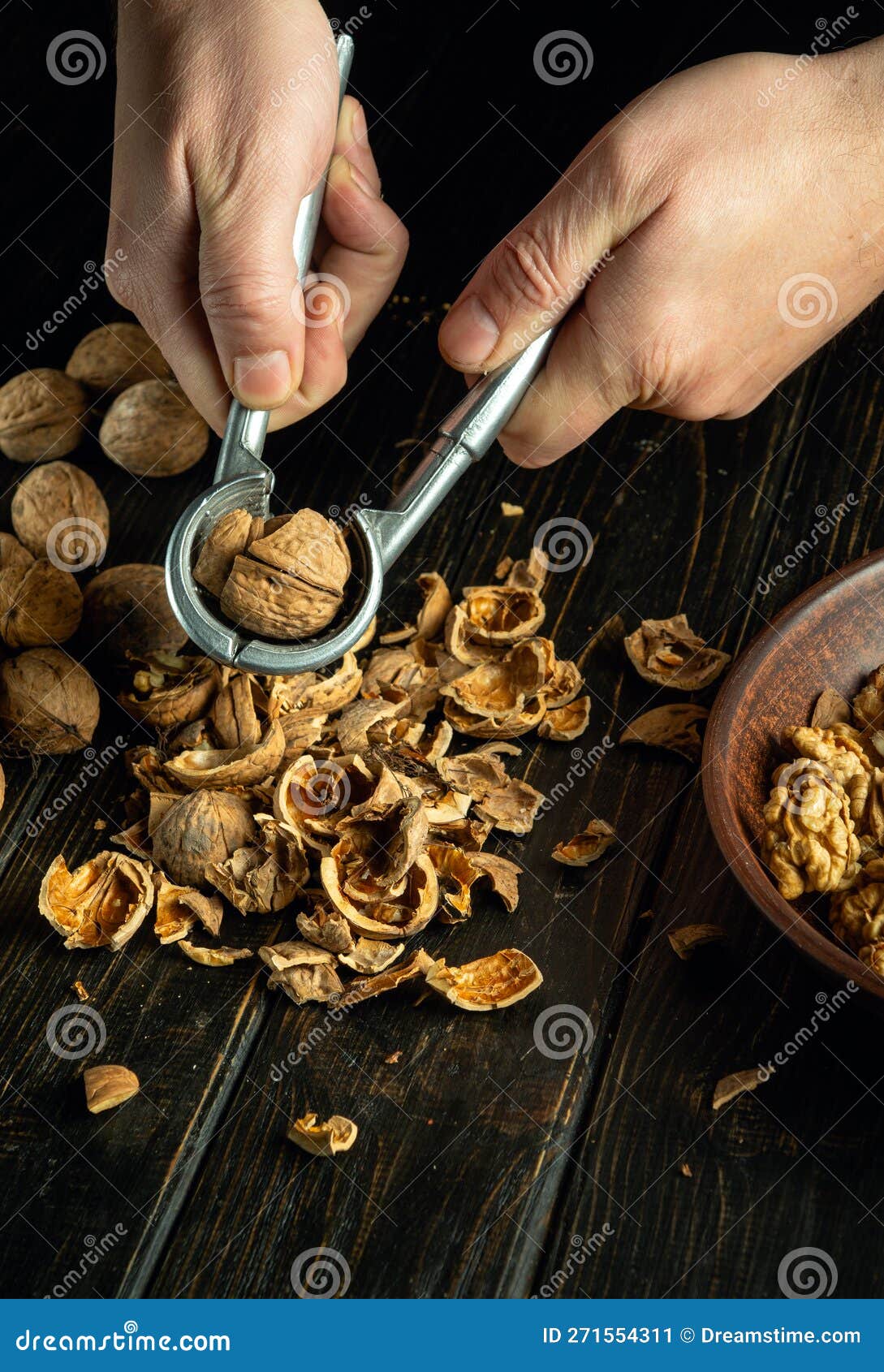 Peeling Walnuts from a Hard Shell by the Hands of Chef Using a