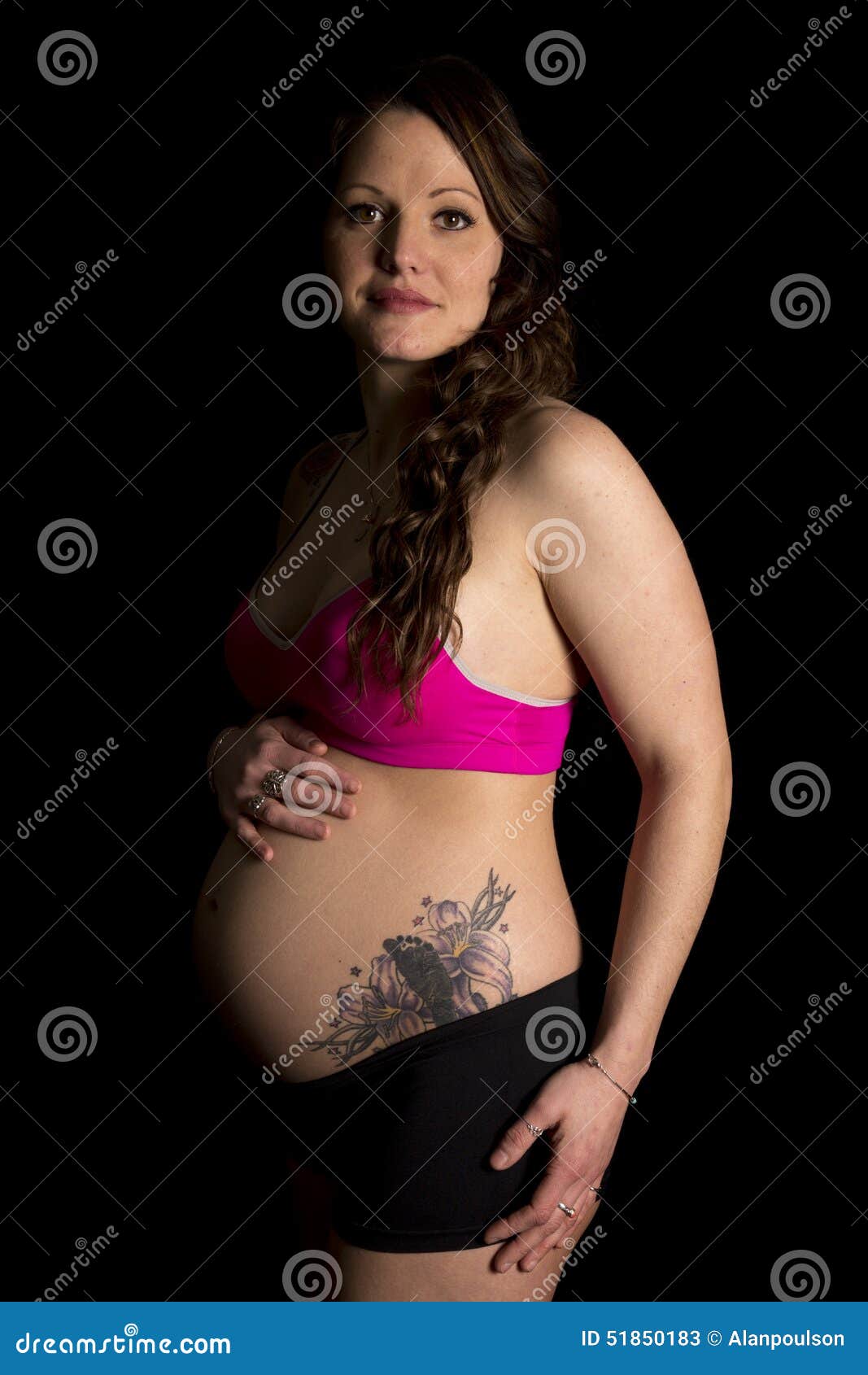 https://thumbs.dreamstime.com/z/pegnant-woman-pink-sports-bra-side-lit-look-pregnant-her-looking-small-smile-showing-her-baby-foot-tattoo-51850183.jpg