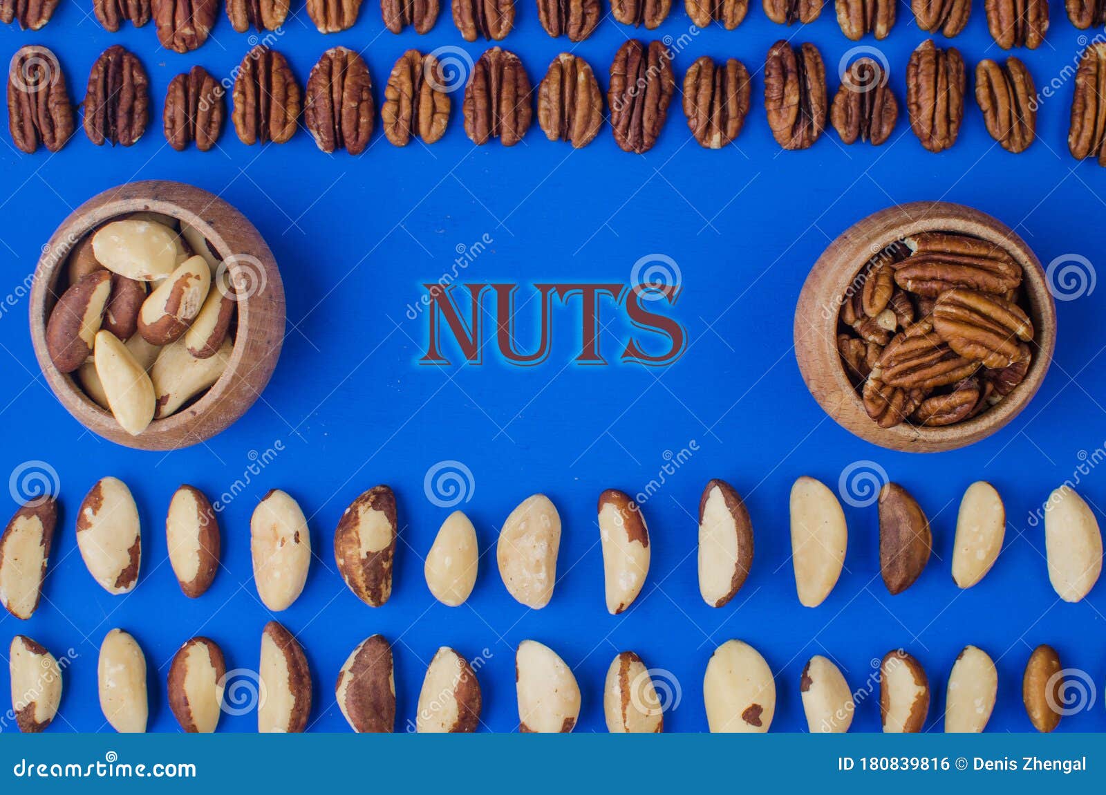 pekan and brazil nuts on blue background. healthy food