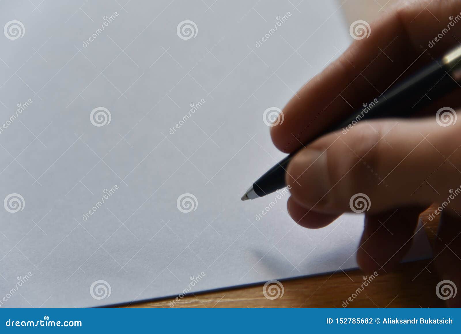 Pen in Hand on White Paper on the Table in the Office Stock Photo ...