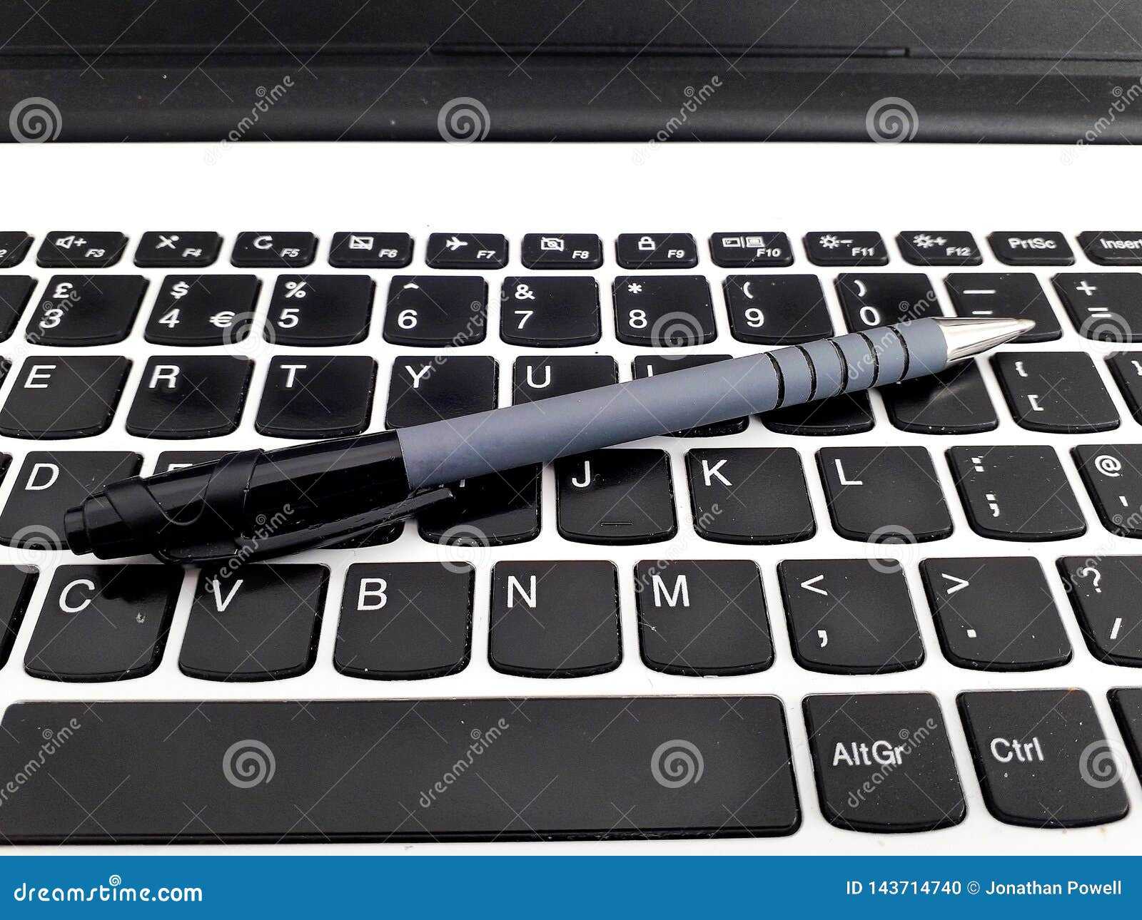 pen resting on a laptop keyboard whilst taking a break