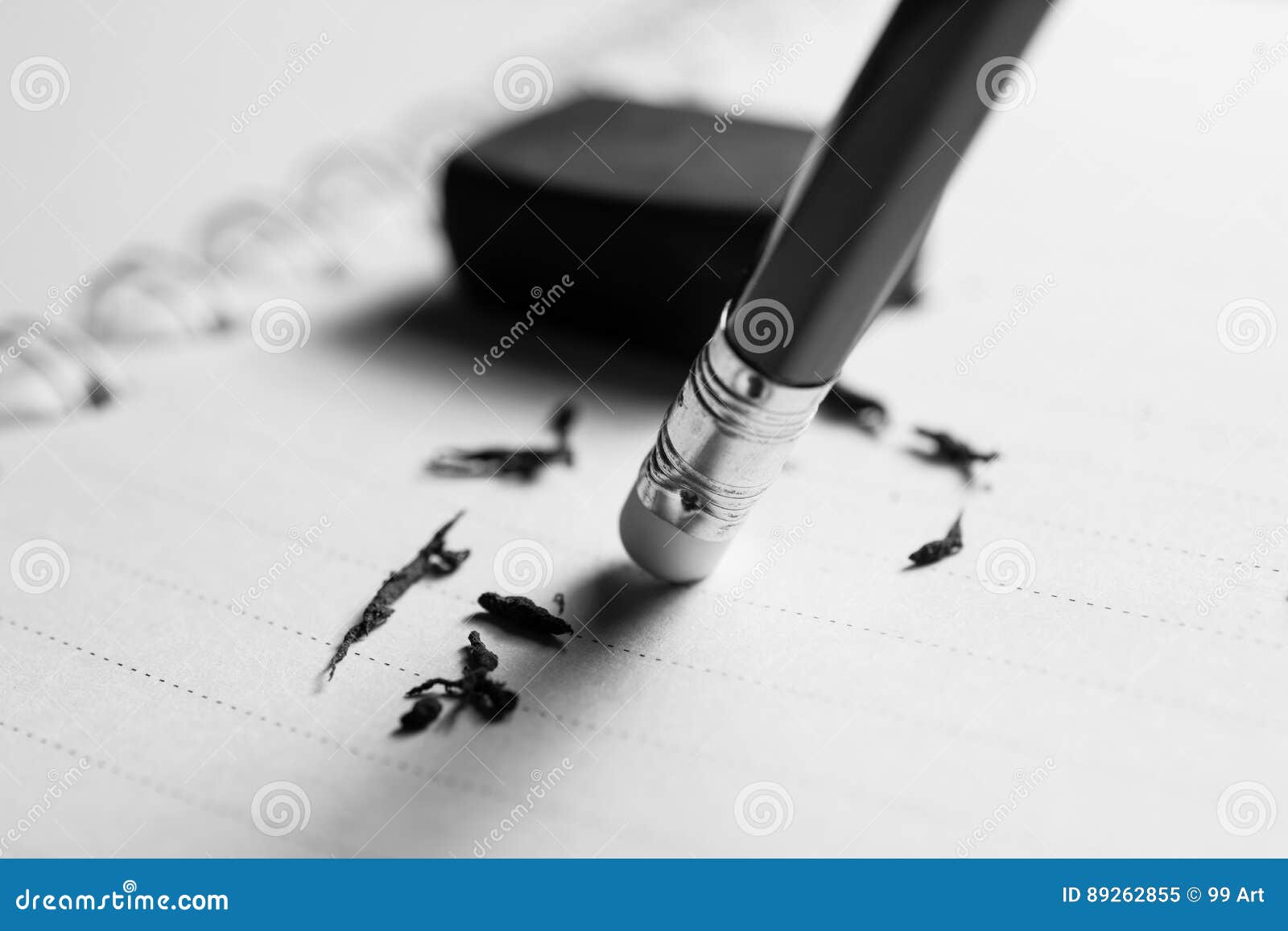 pencil eraser removing a written mistake on a piece of paper, de