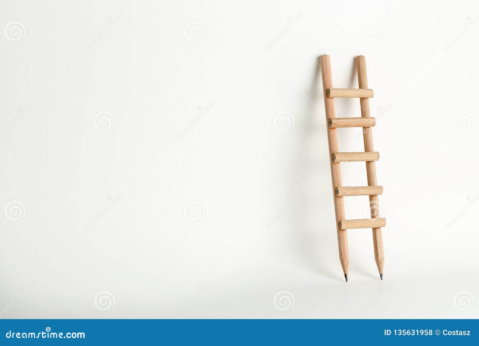 Pencil Ladder Lean On Concrete Wall In Dark Room And Leading To Key