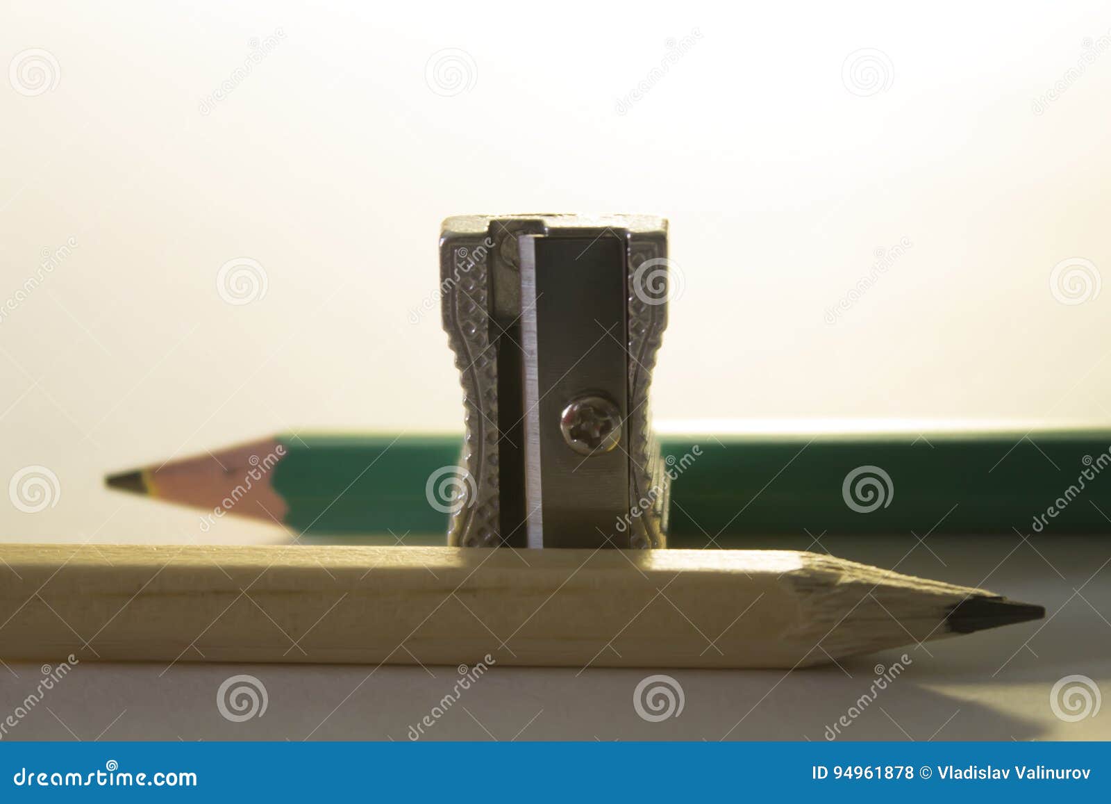 Pencil Sharpener between Two Different Colored Pencils in the Backlight