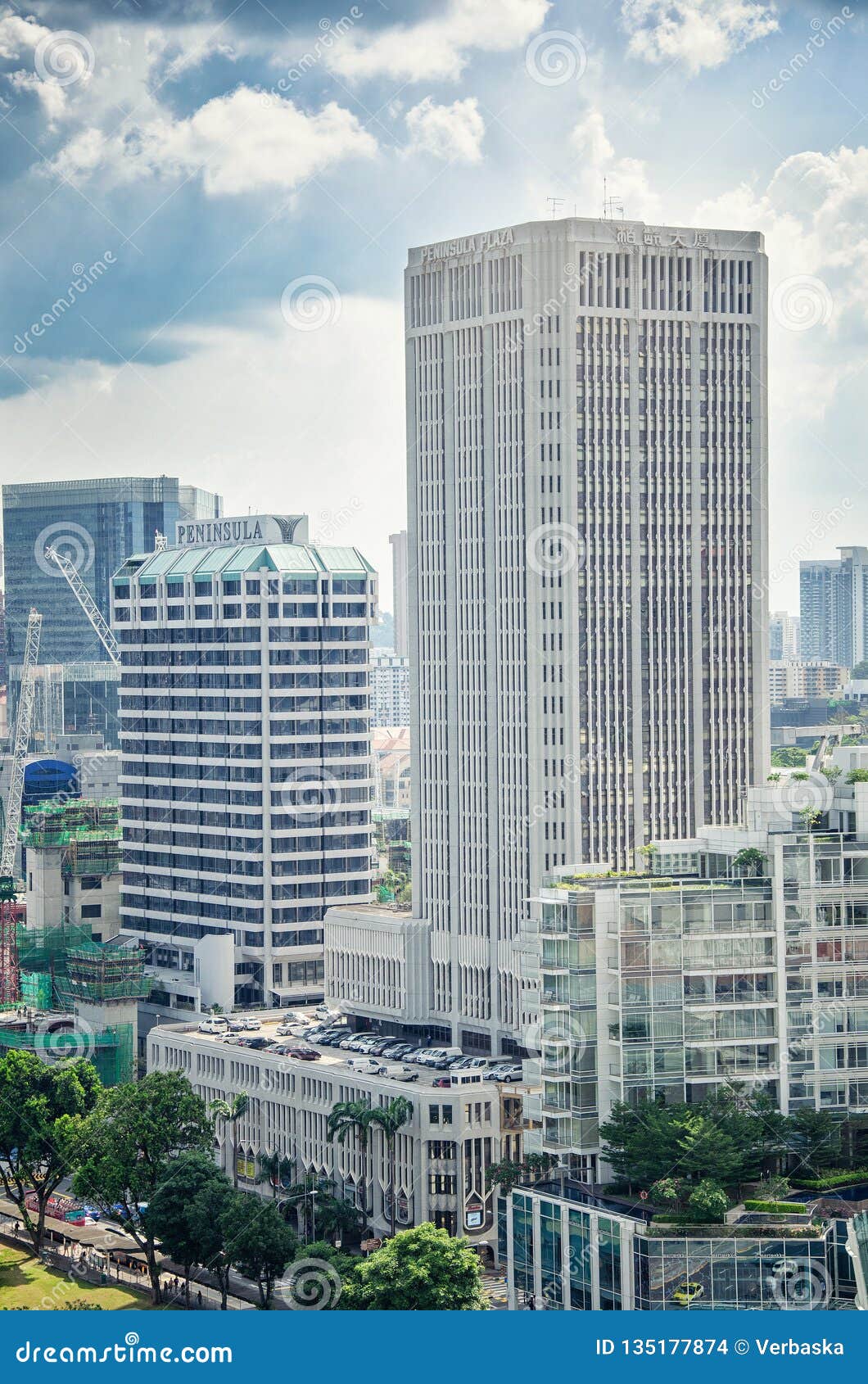 Tall square rectangular of Peninsula Plaza 30-floor tower distinguishes from other towers by its external grey ribs.