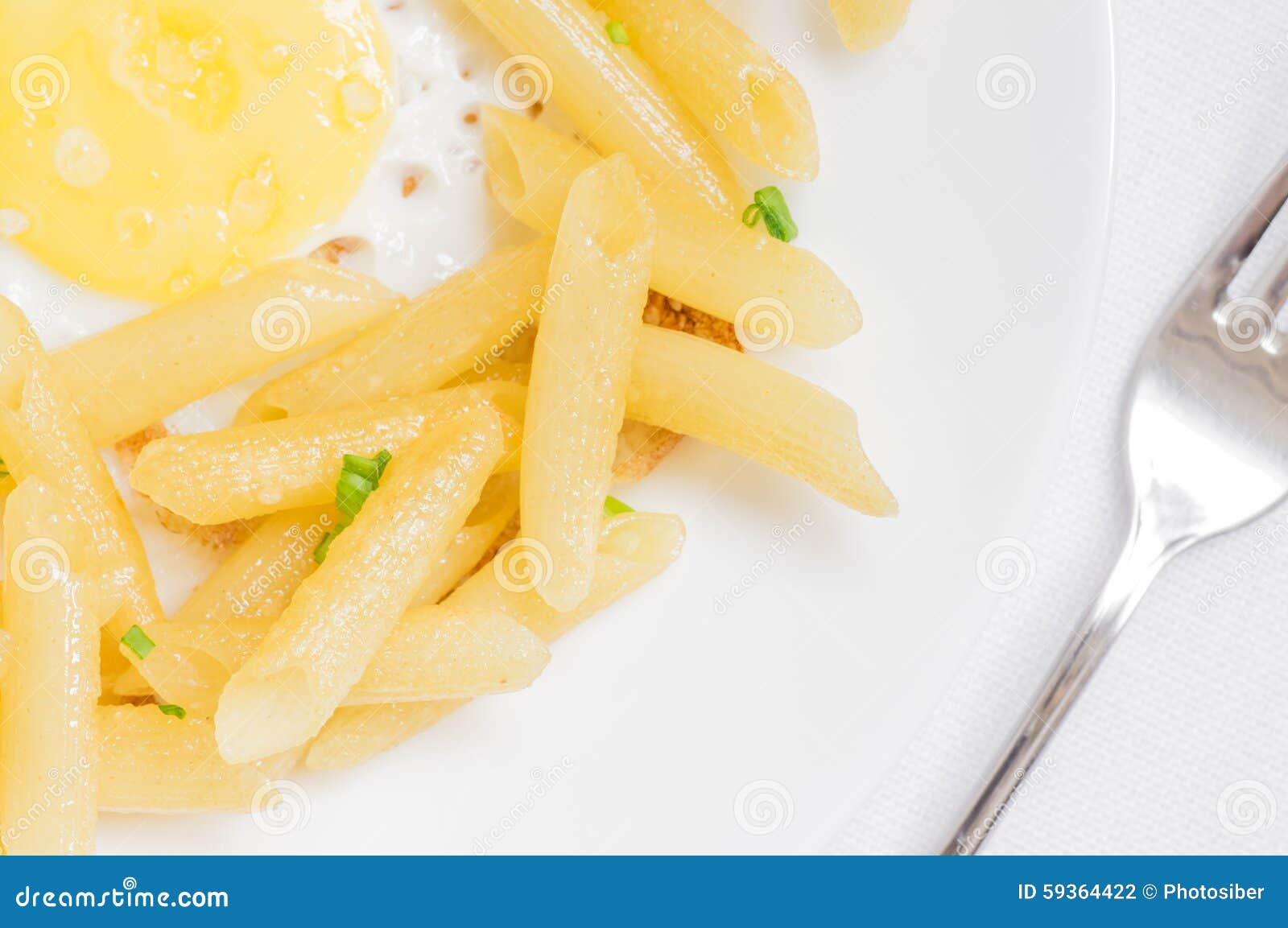 Penne Pasta Edge of the Plate with a Fried Egg Yolk Stock Photo Image