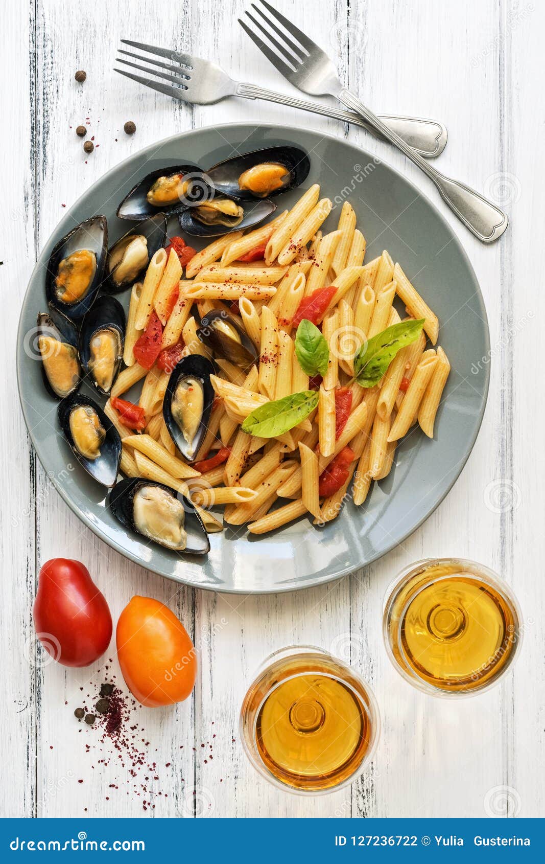 Penne Pasta with Mussels, Tomatoes and White Wine on a White Wooden ...