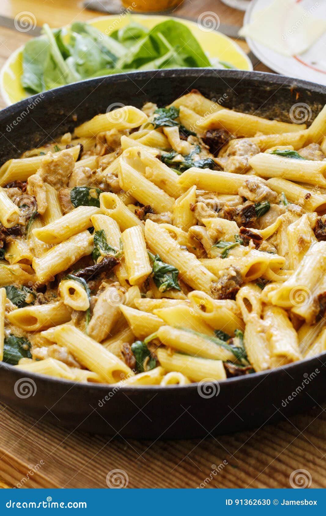 Penne with Sun Dried Tomatoes, Chicken and Spinach Stock Photo Image