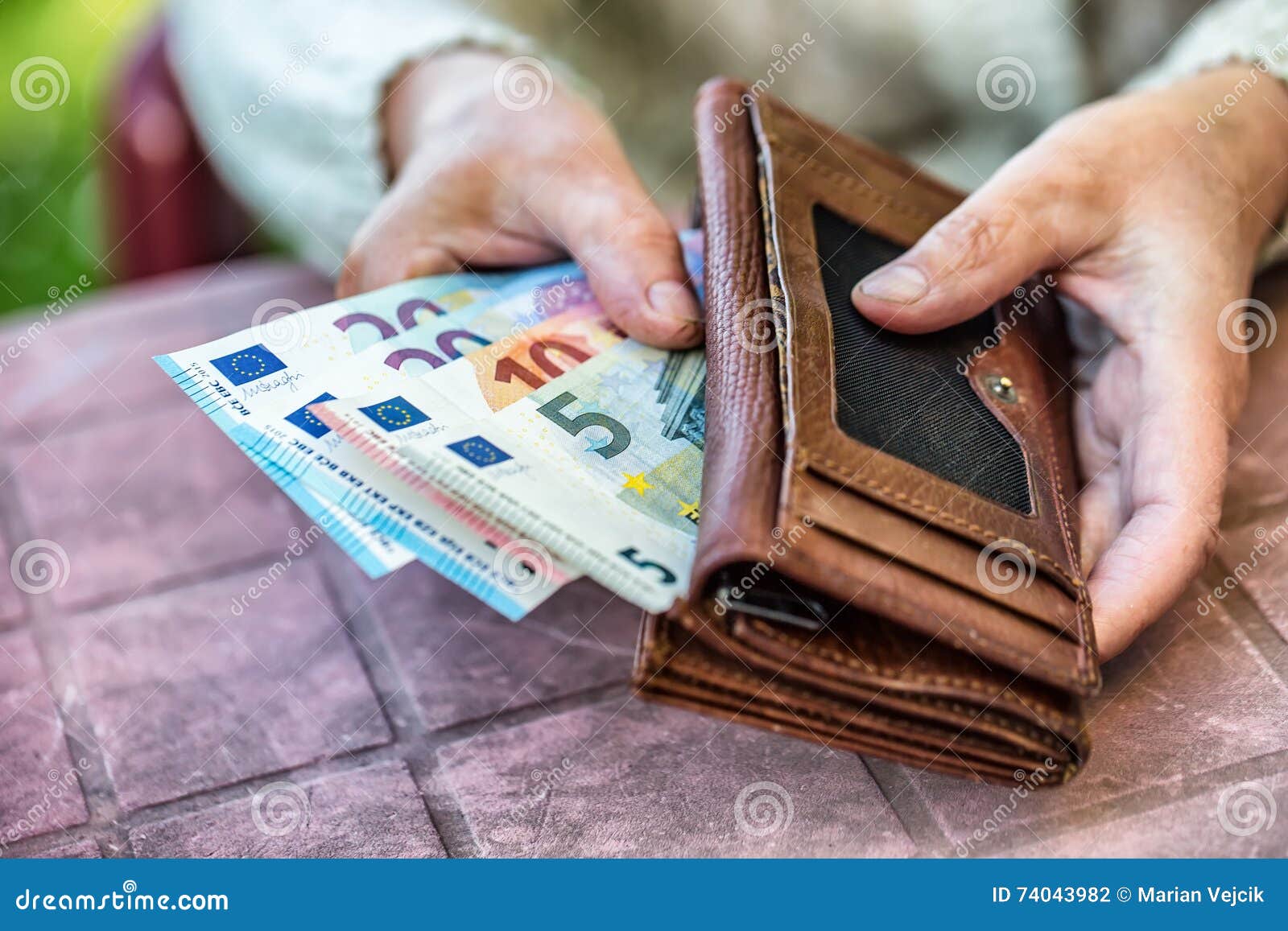 pensioner woman holding in hands wallet without money