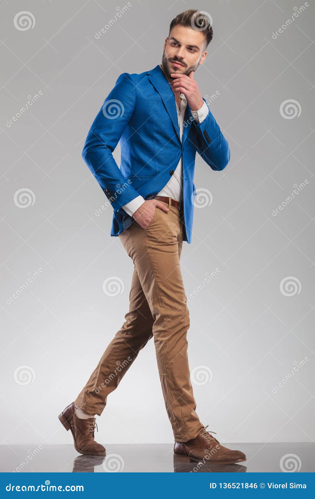 Pensive Businessman Walks To Side with Hand in Pockets Stock Photo ...