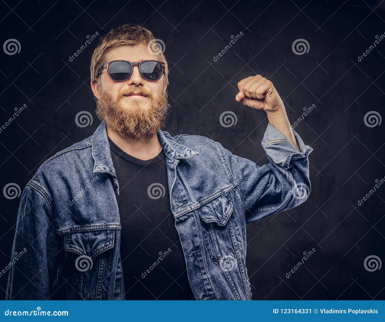 Pensive Hipster Guy Wearing Sunglasses Dressed in Jeans Jacket Shows ...