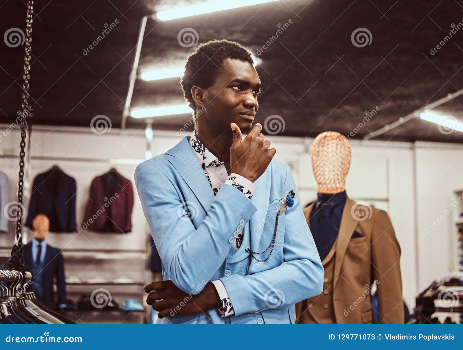 Elegantly Dressed African Man Posing with Hand on Chin while Standing ...