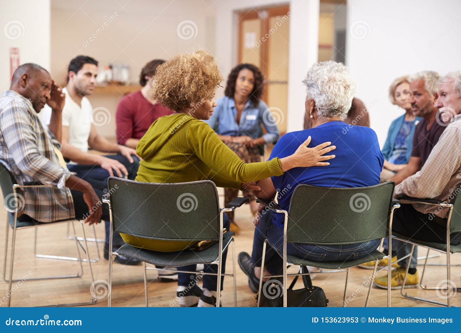 people attending self help therapy group meeting in community center