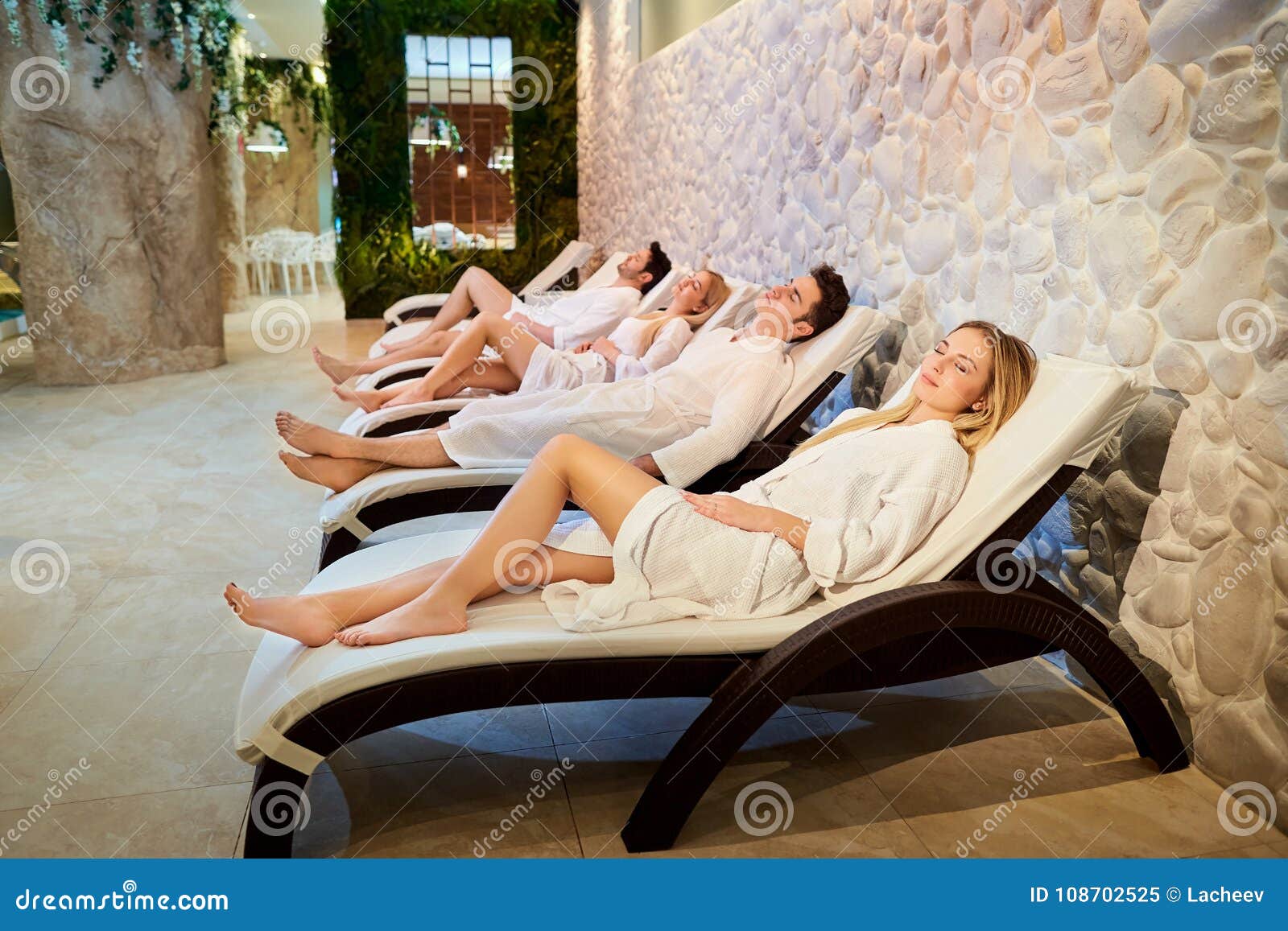 people in bathrobes are resting in the spa salon.