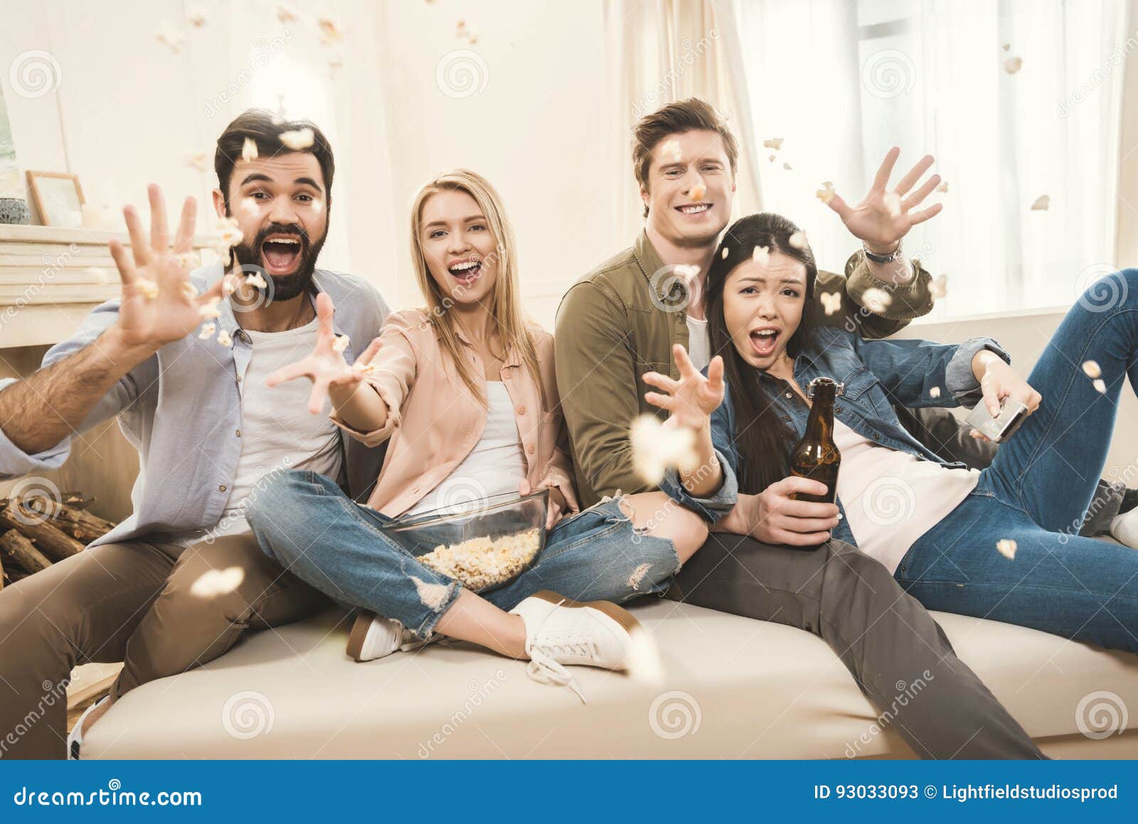 People on Couch Throwing Popcorn Upside Stock Image Image of laughing