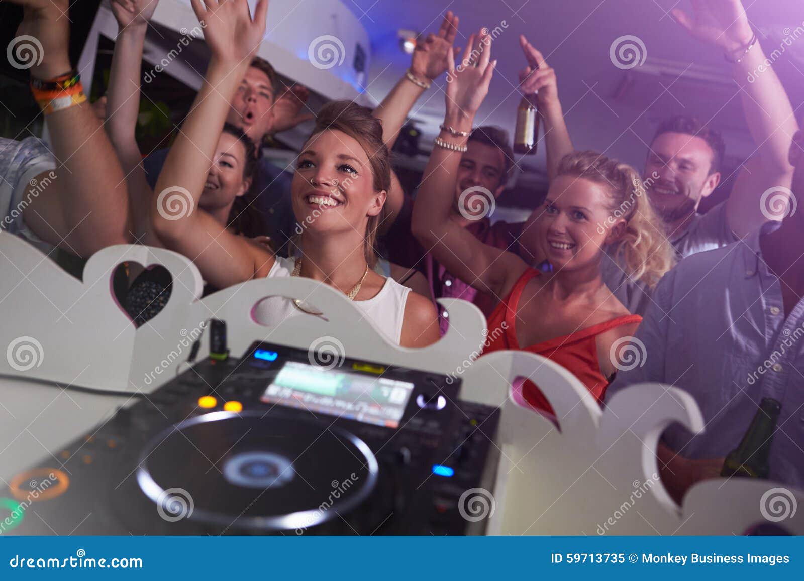 People Dancing in Nightclub with DJ in Foreground Stock Image - Image ...