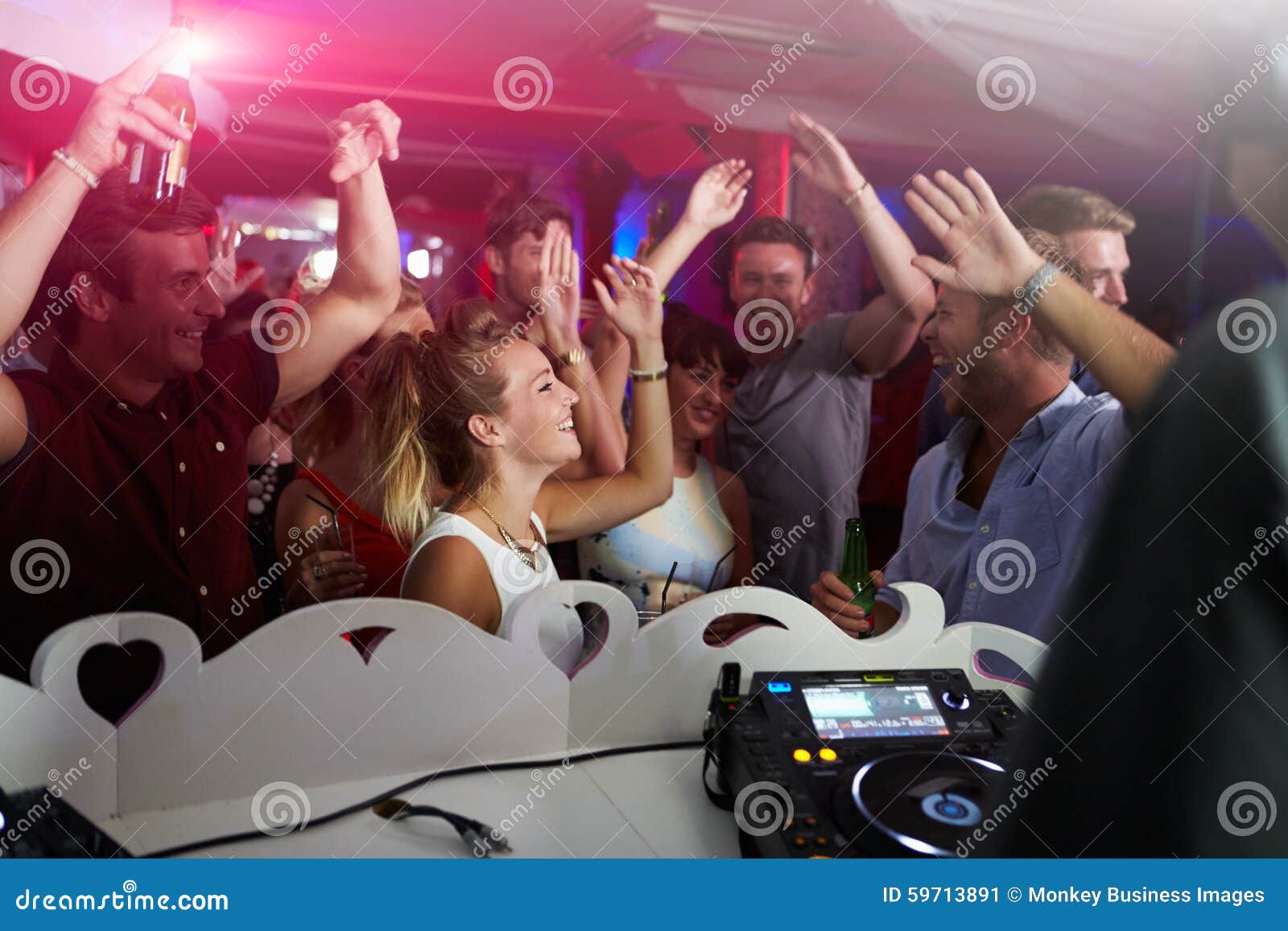 People Dancing in Nightclub with DJ in Foreground Stock Image - Image ...