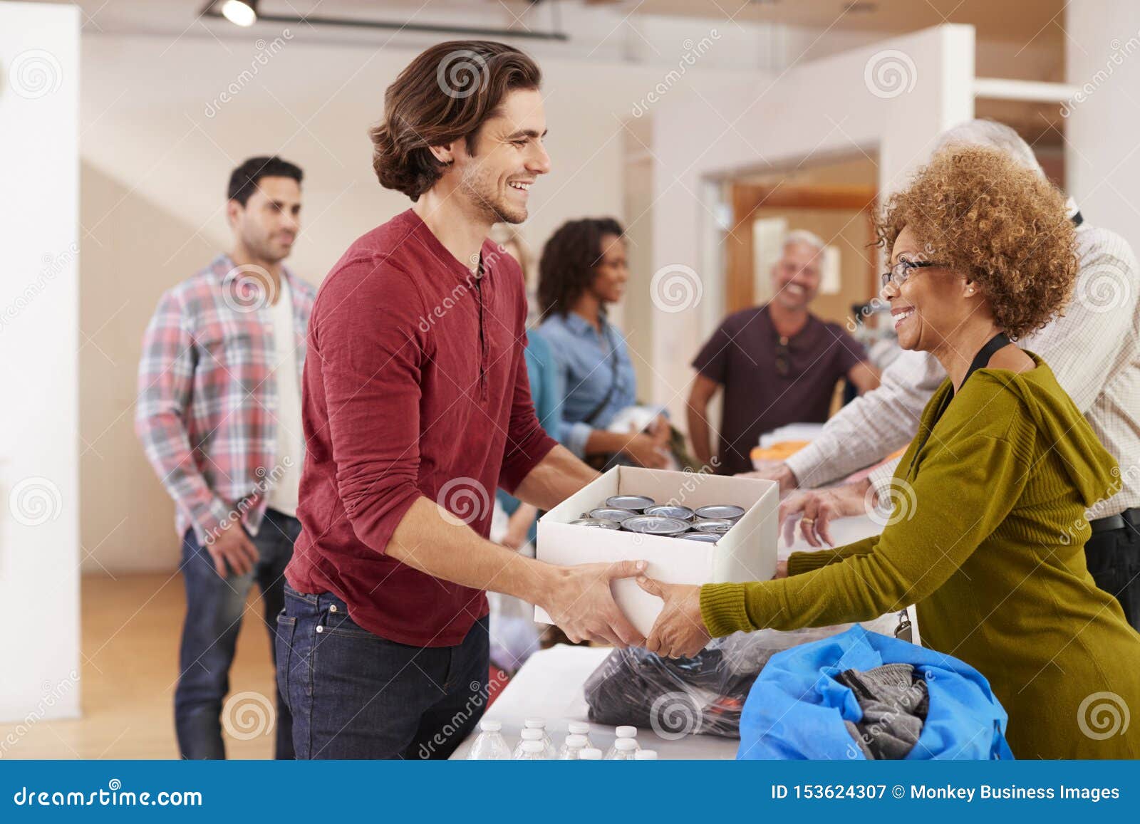 people donating food to charity food bank collection in community center