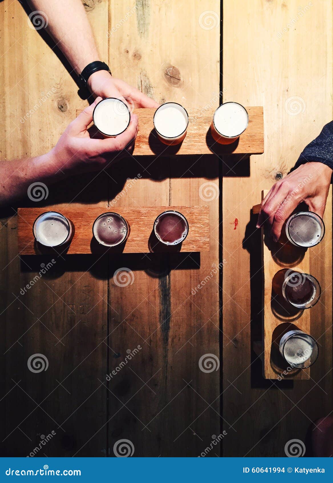 people drinking local beer from tasting palettes at craft brewery