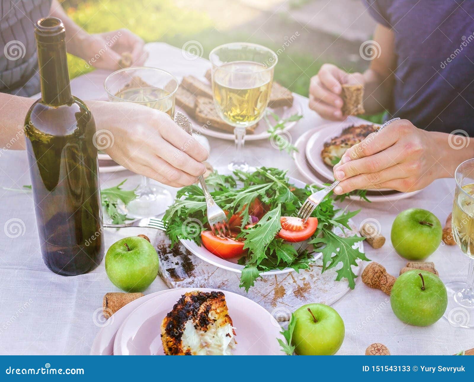 People Eat In The Garden At The Table Dinner Concept With Wine In