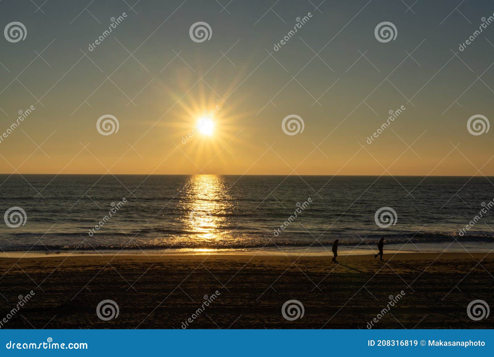 People Enjoy an Evening Walk on an Empty Golden Sand Beach at Sunset ...