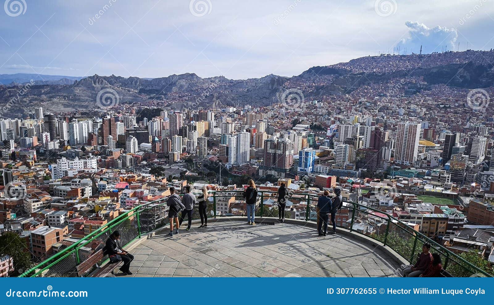 people enjoying the view of a large city from a lookout point