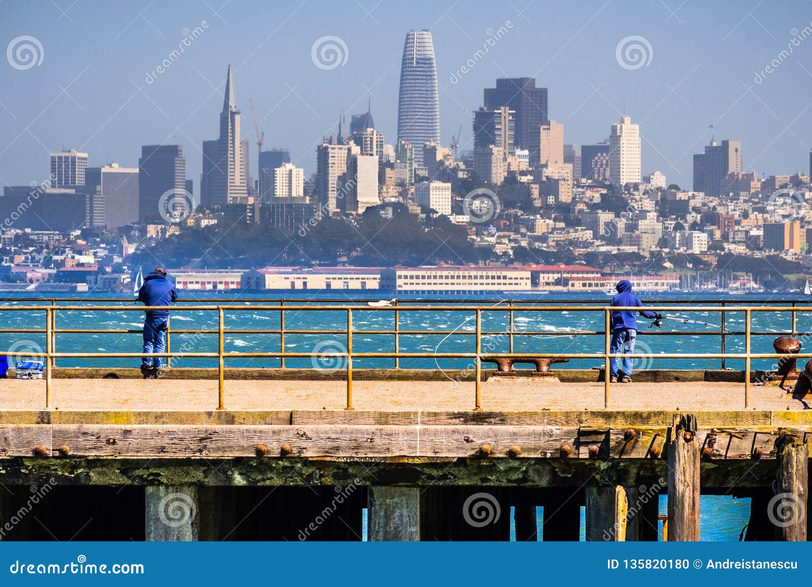 People Fishing From One Of The Piers Facing The San