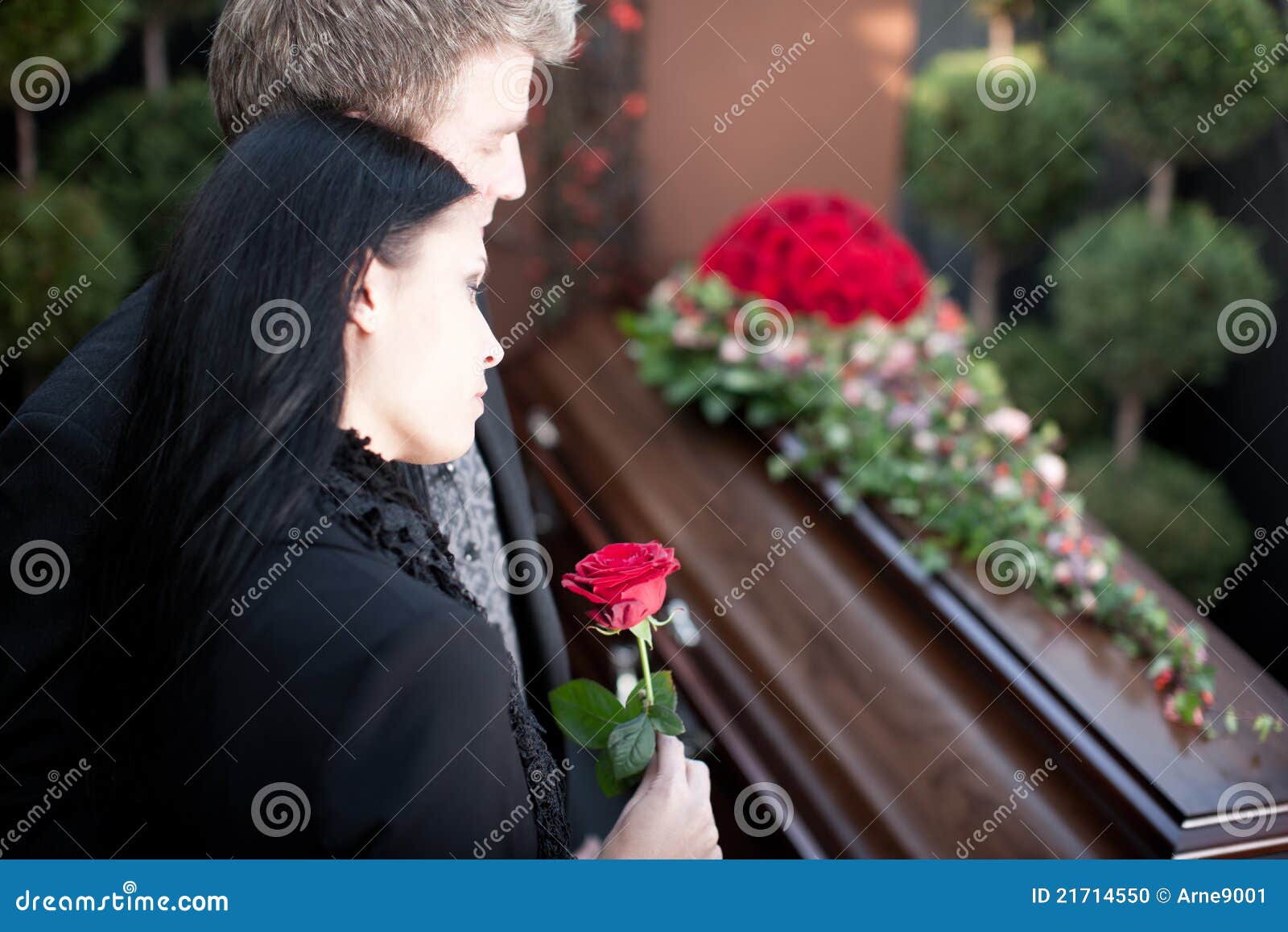people at funeral with coffin
