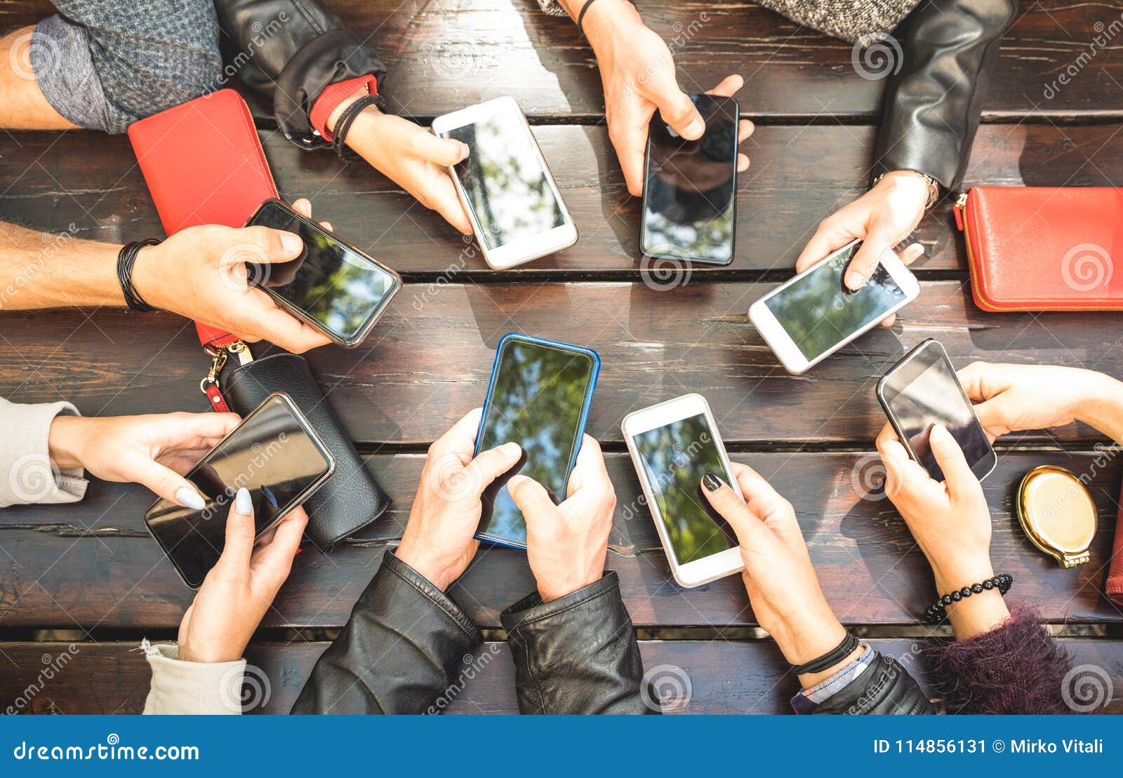 people group having addicted fun together using smartphones - de