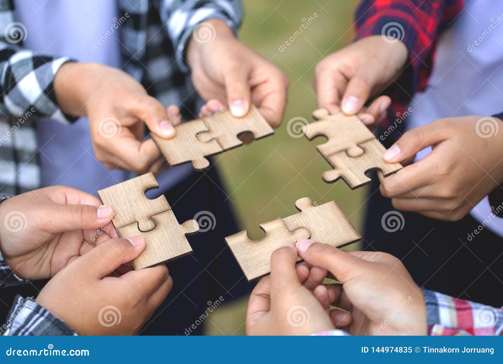 people helping in assembling puzzle, cooperation in decision making, team support in solving problems and corporate group teamwork