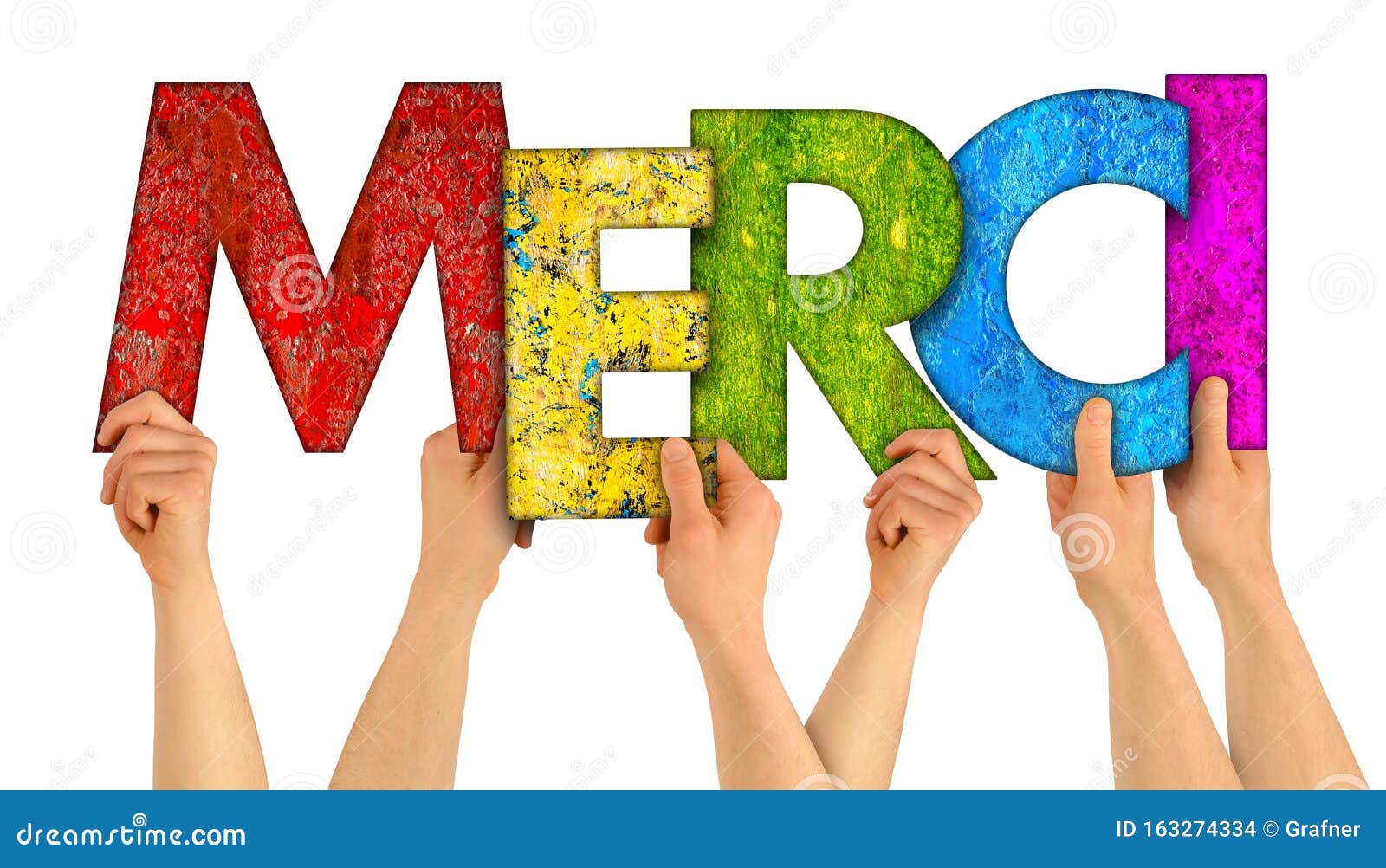 people holding up colorful rainbow wooden letter with the french word merci english traslation: thank you  white