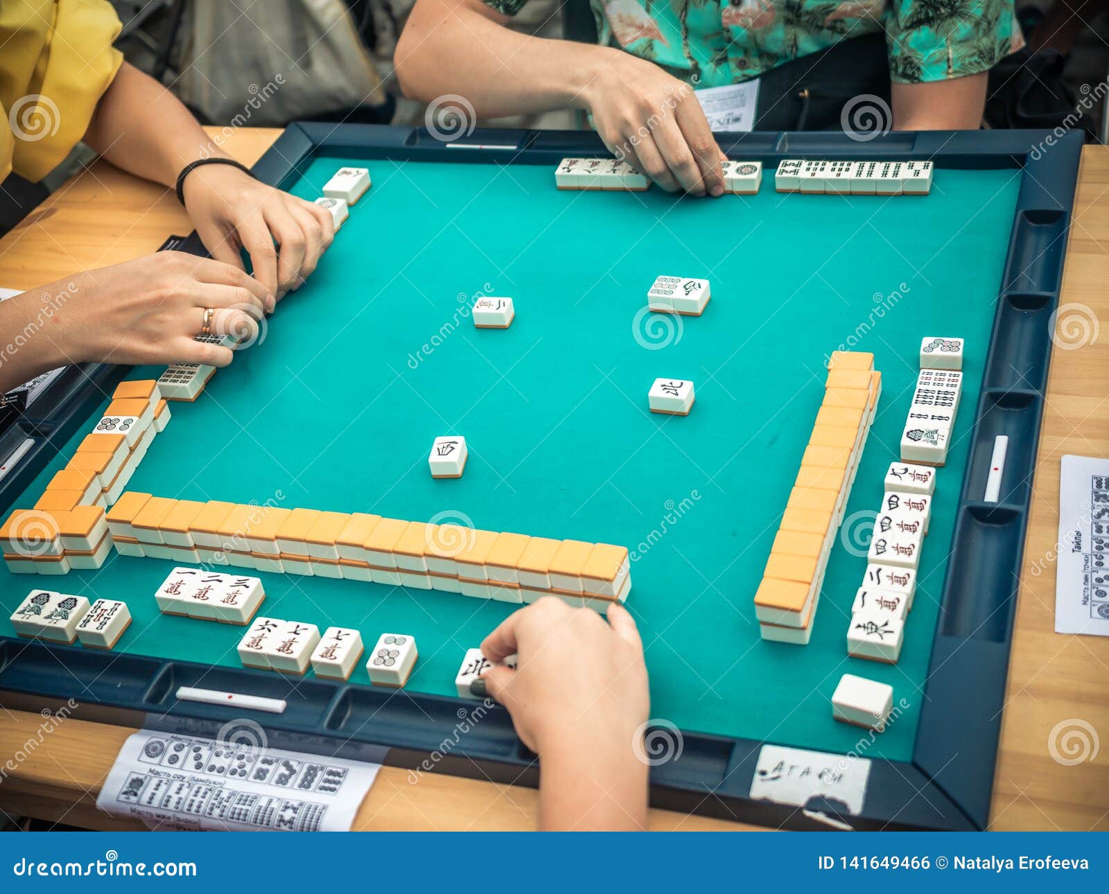 People Playing Mahjong Asian Tilebased Game. Table Gambling Top View