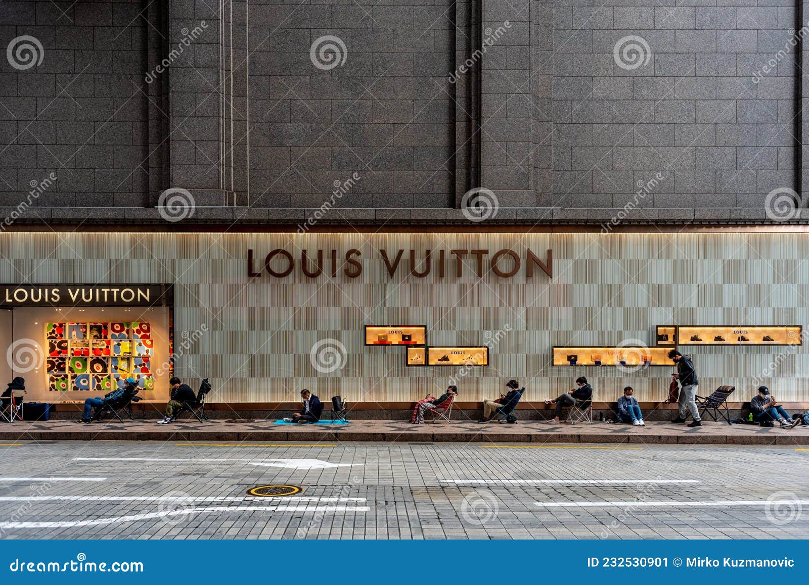 People Queue in Line Waiting To Enter Louis Vuitton Store in Seoul