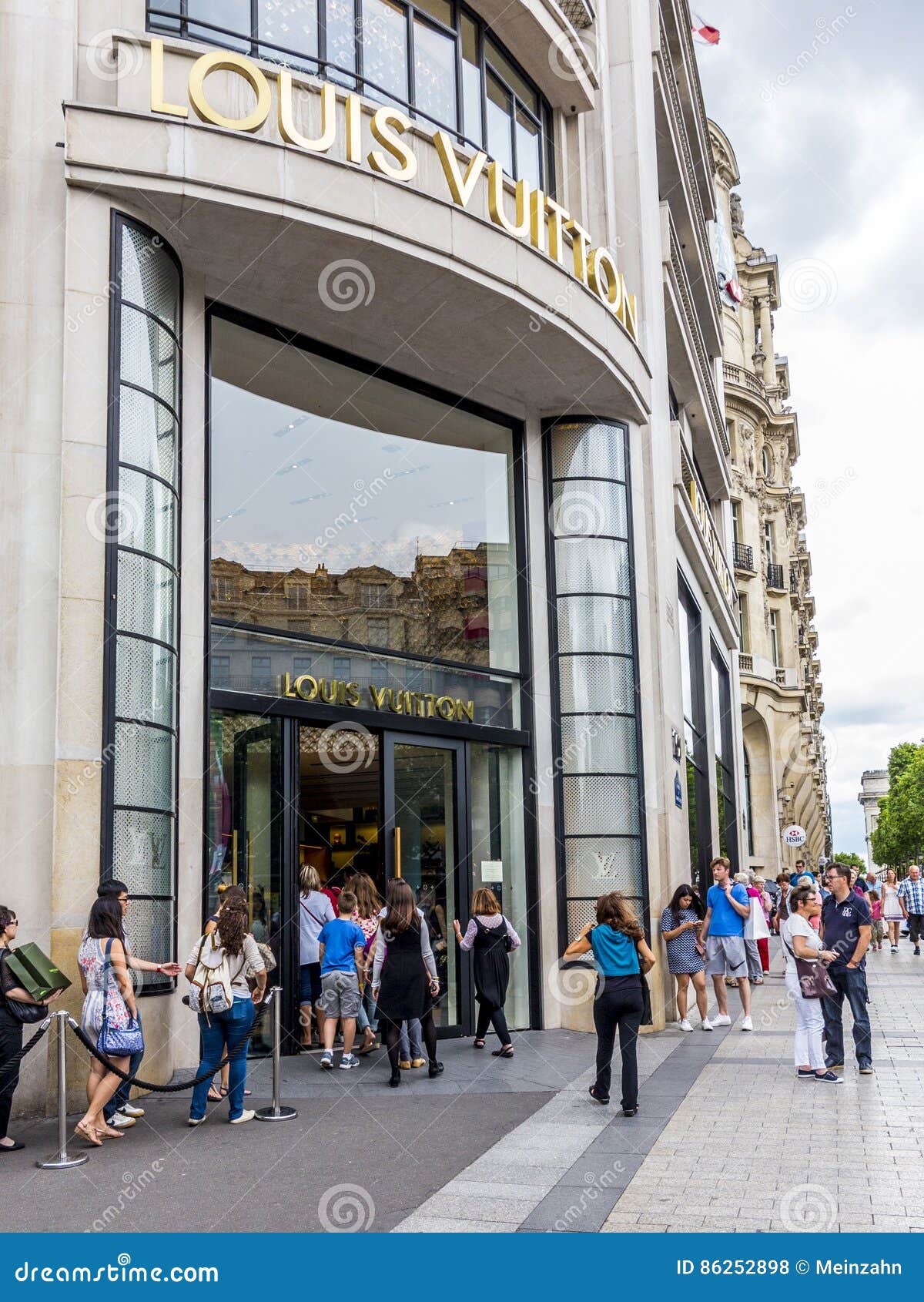 Queue of shoppers outside Louis Vuitton store on Champs Elysees in Paris  France