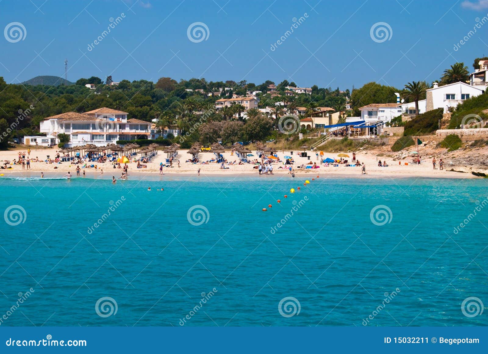 people relax on public beach of cala romantica