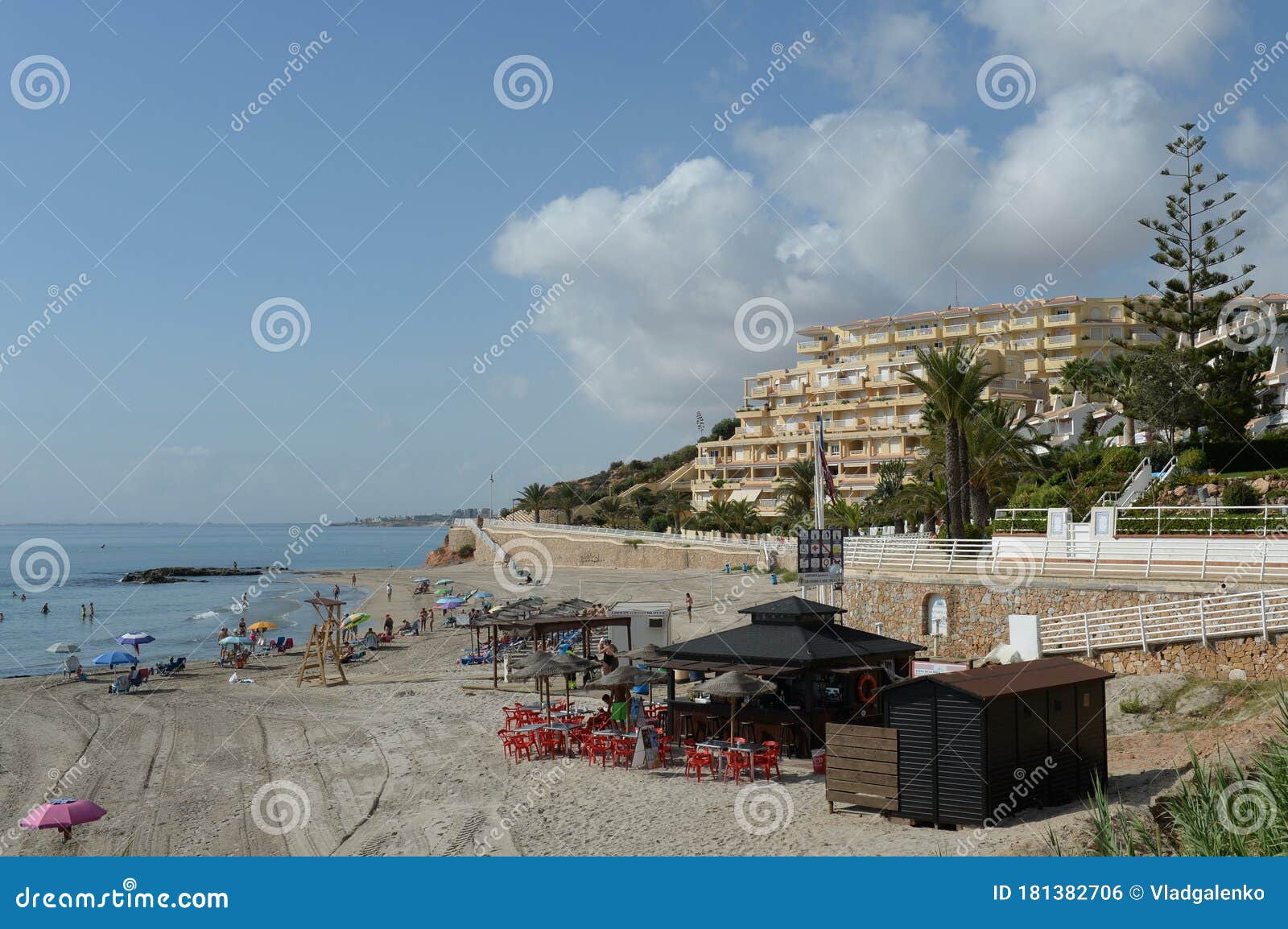 people relax on the sandy beach of playa de aguamarina, province of alicante, spain