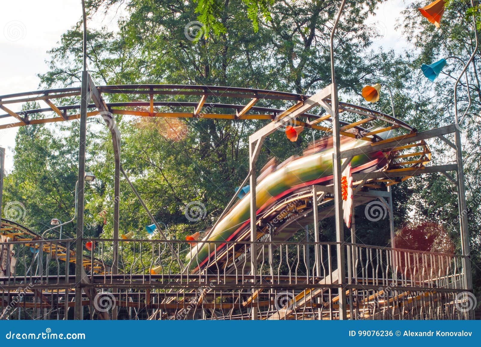 People Ride on a Roller Coaster in an Amusement Park Stock Photo