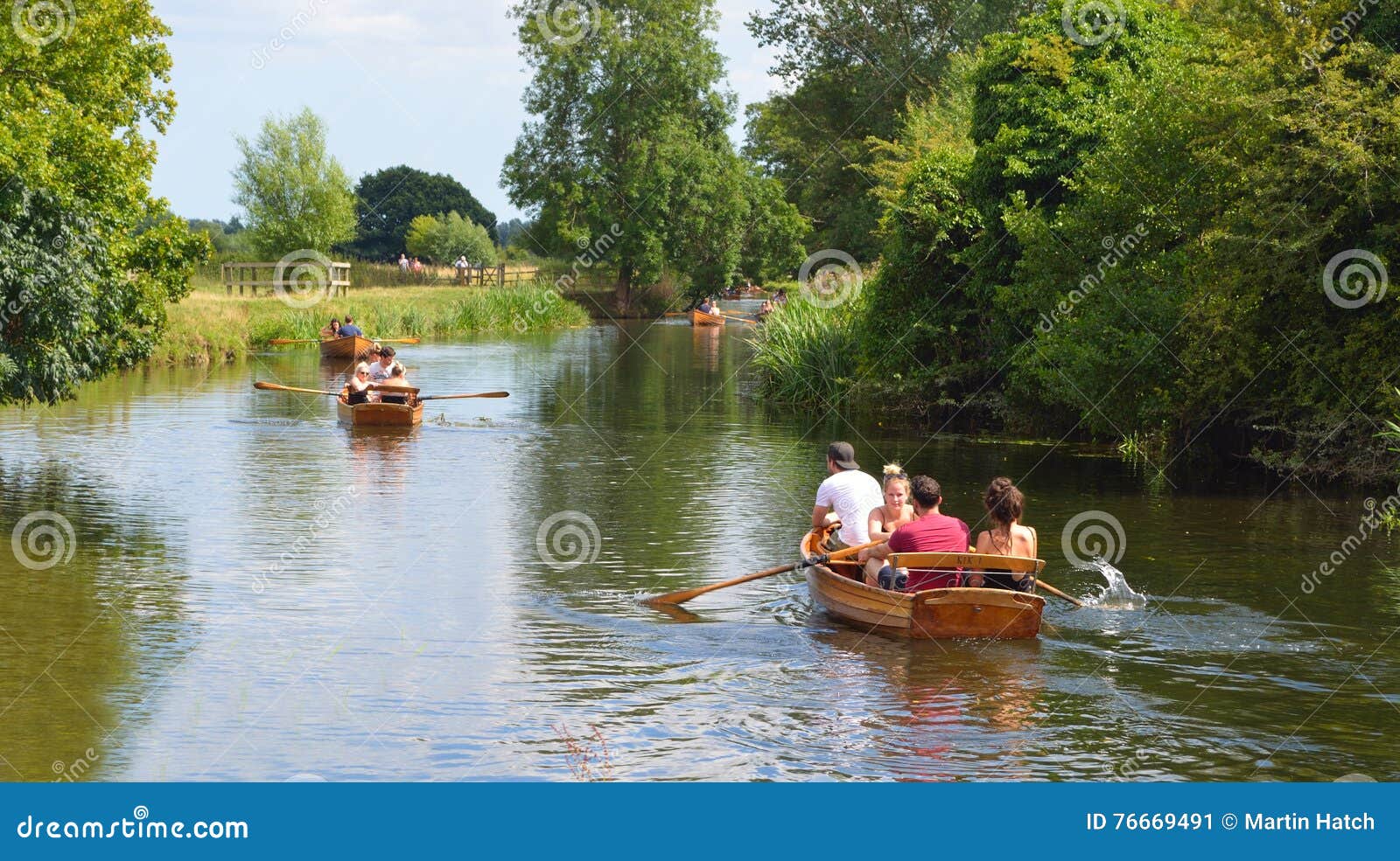 people rowing boats on the river stour editorial photo