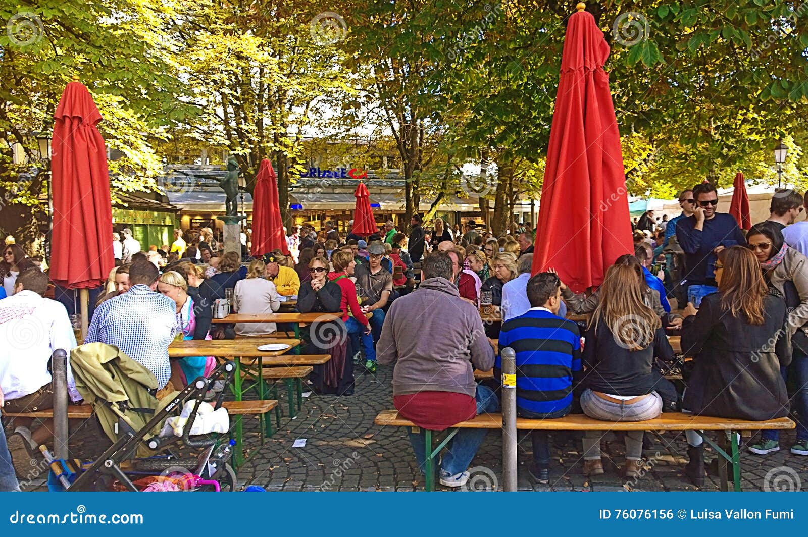 People Seat And Chat At Beer Garden In Viktualienmarkt Munich