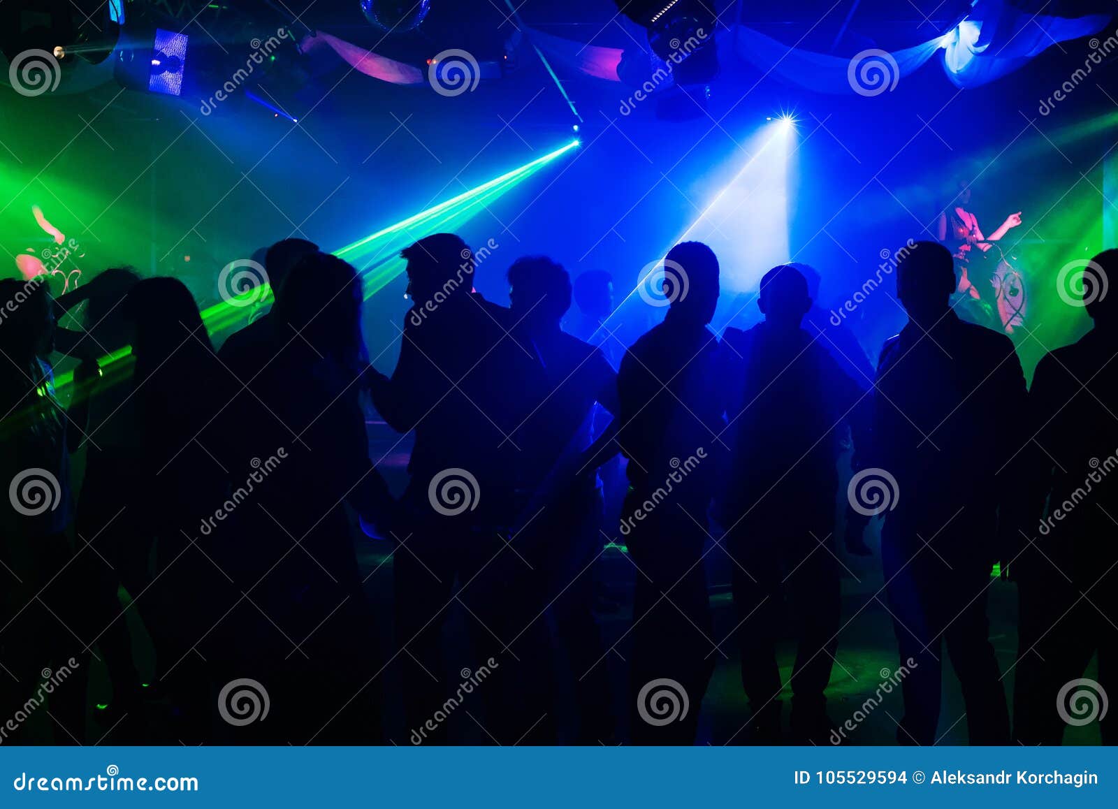 People Silhouettes on Dance Floor of Night Club To Laser Projectors ...