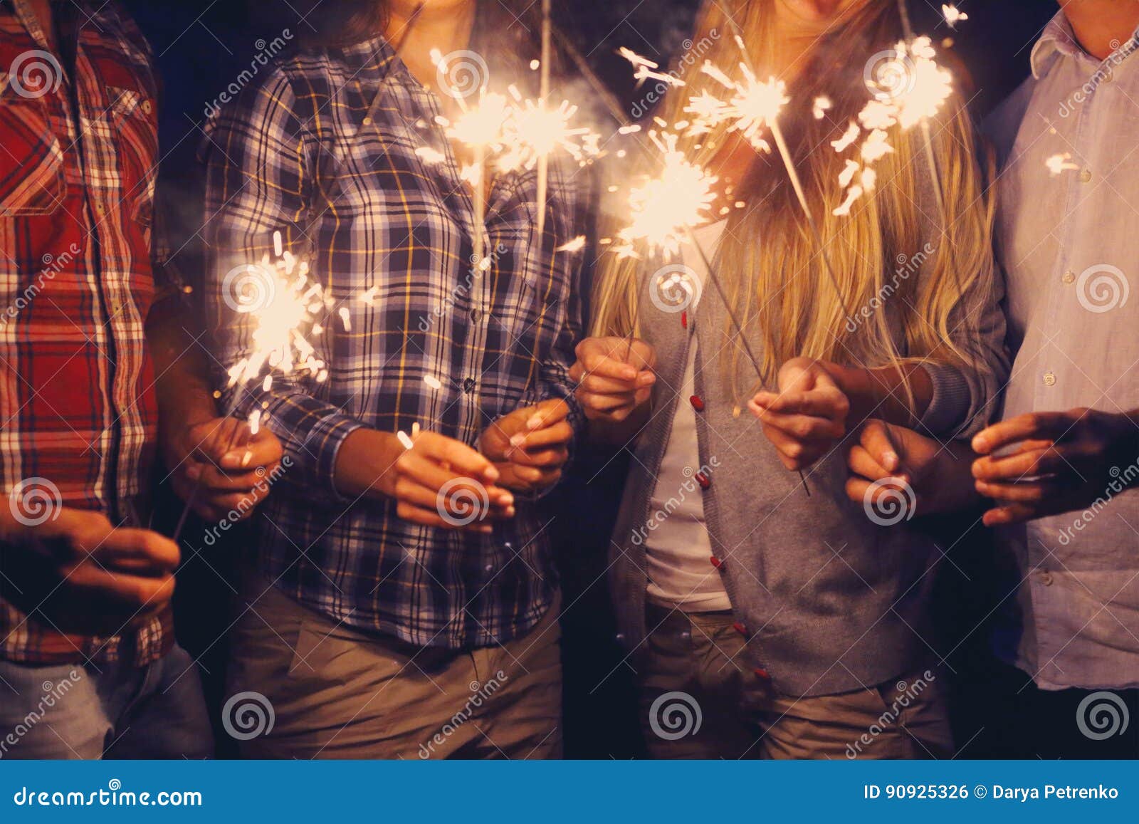 people with sparklers on outdoor party