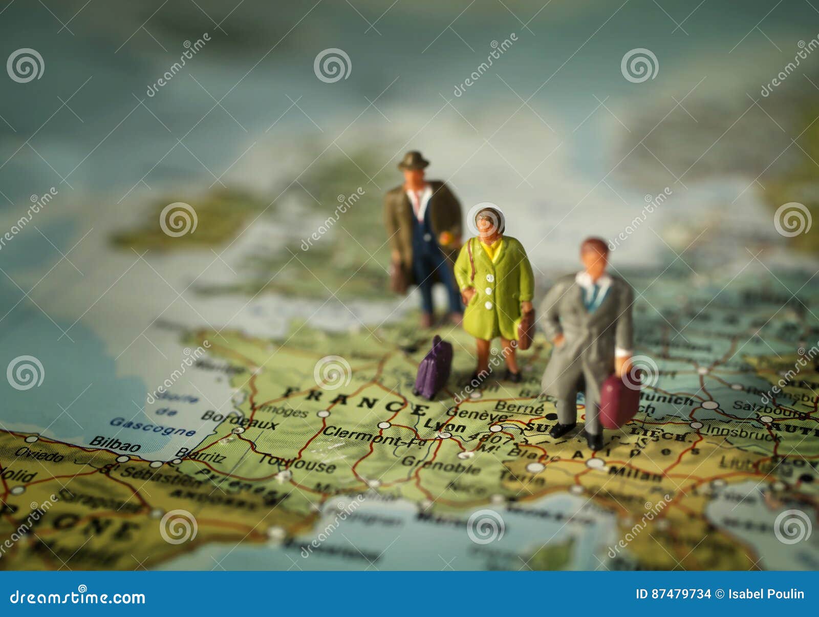 People standing on France in Europe. Mini people standing with luggages on a map