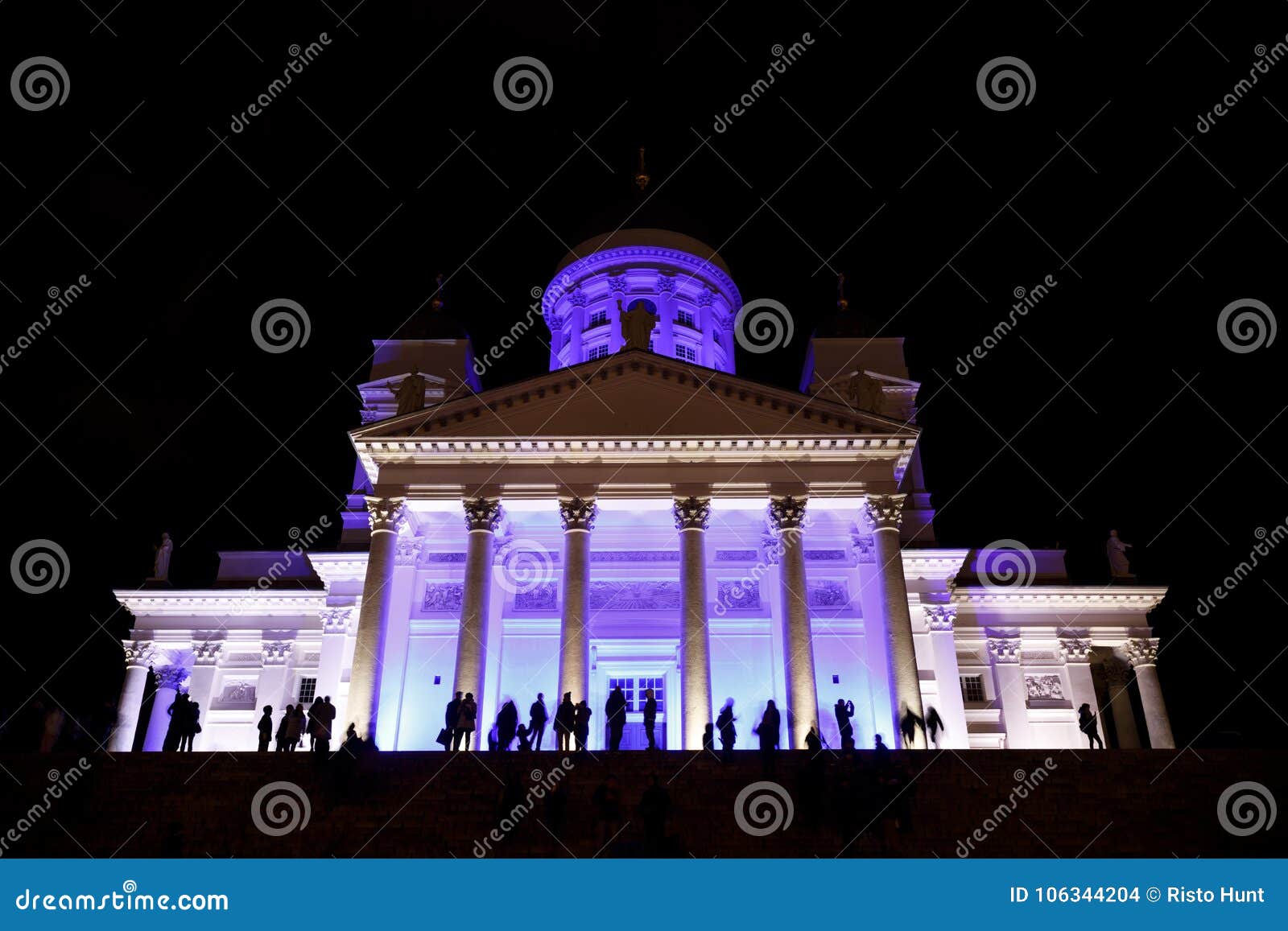 people stant in front of illuminated helsinki st nicholas cathed