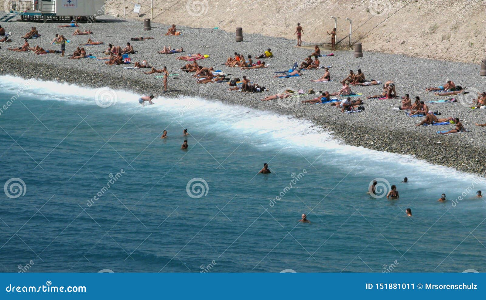 People Sun Bathing and Swimming on the Beach of Nice in France, Cote D`Azur and Mediterranean Sea in Summer Editorial Photo image