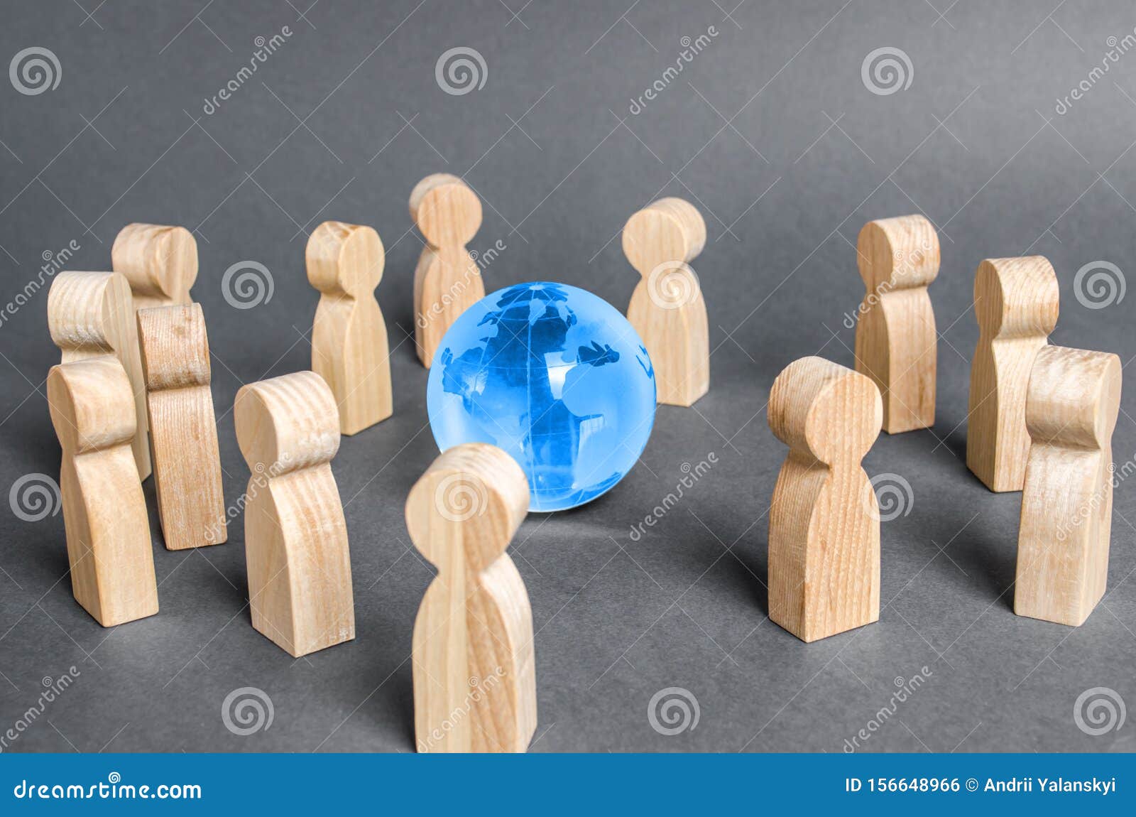 people surrounded a globe world planet earth. cooperation and collaboration of people around the world. outsourcing and joint work