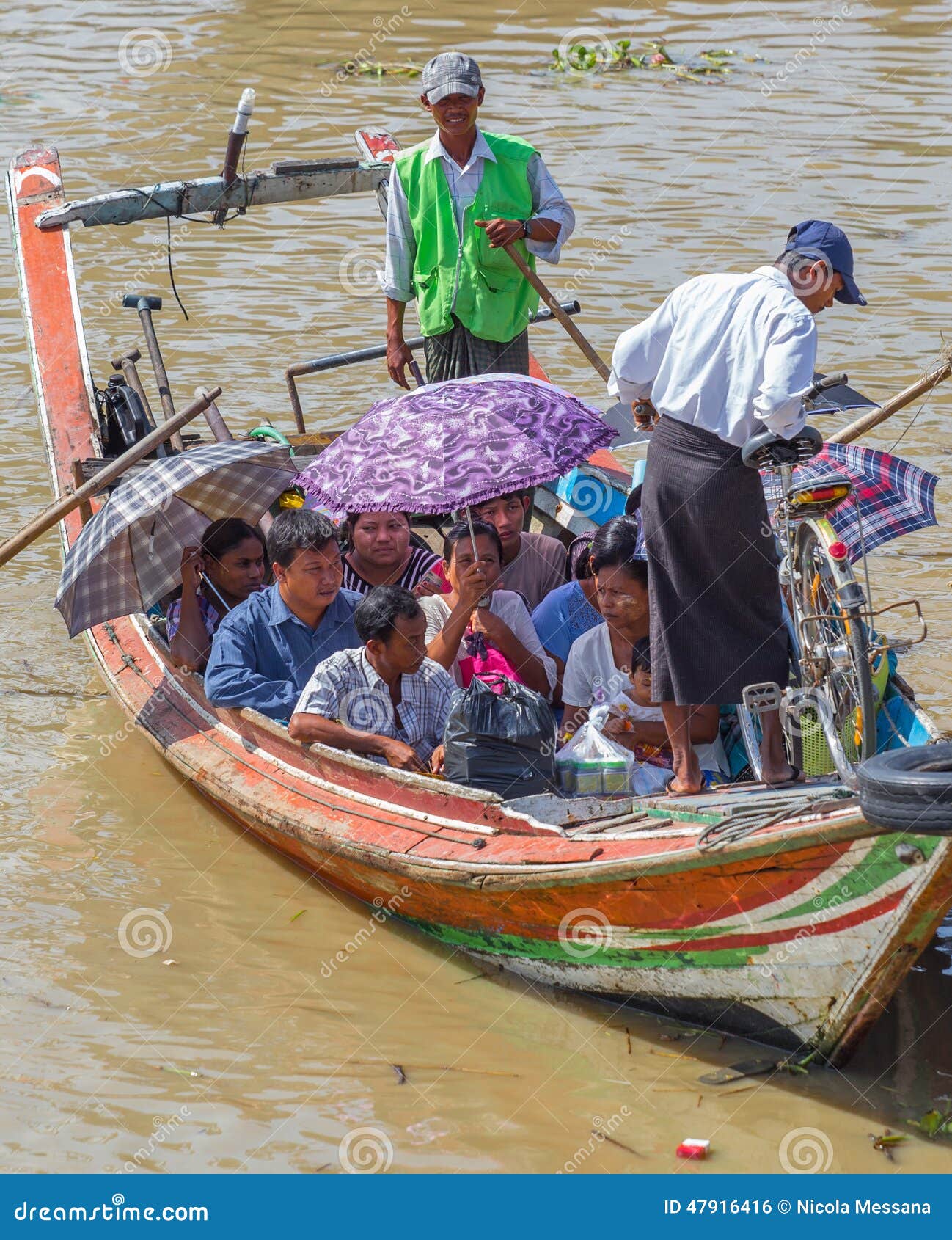 People take the boat to cross the Yangon River, Myanmar. YANGON, MYANMAR - NOVEMBER 22, 2014: several unidentified people take the boat to cross the Yangon River (also known as Rangoon River or Hlaing River)