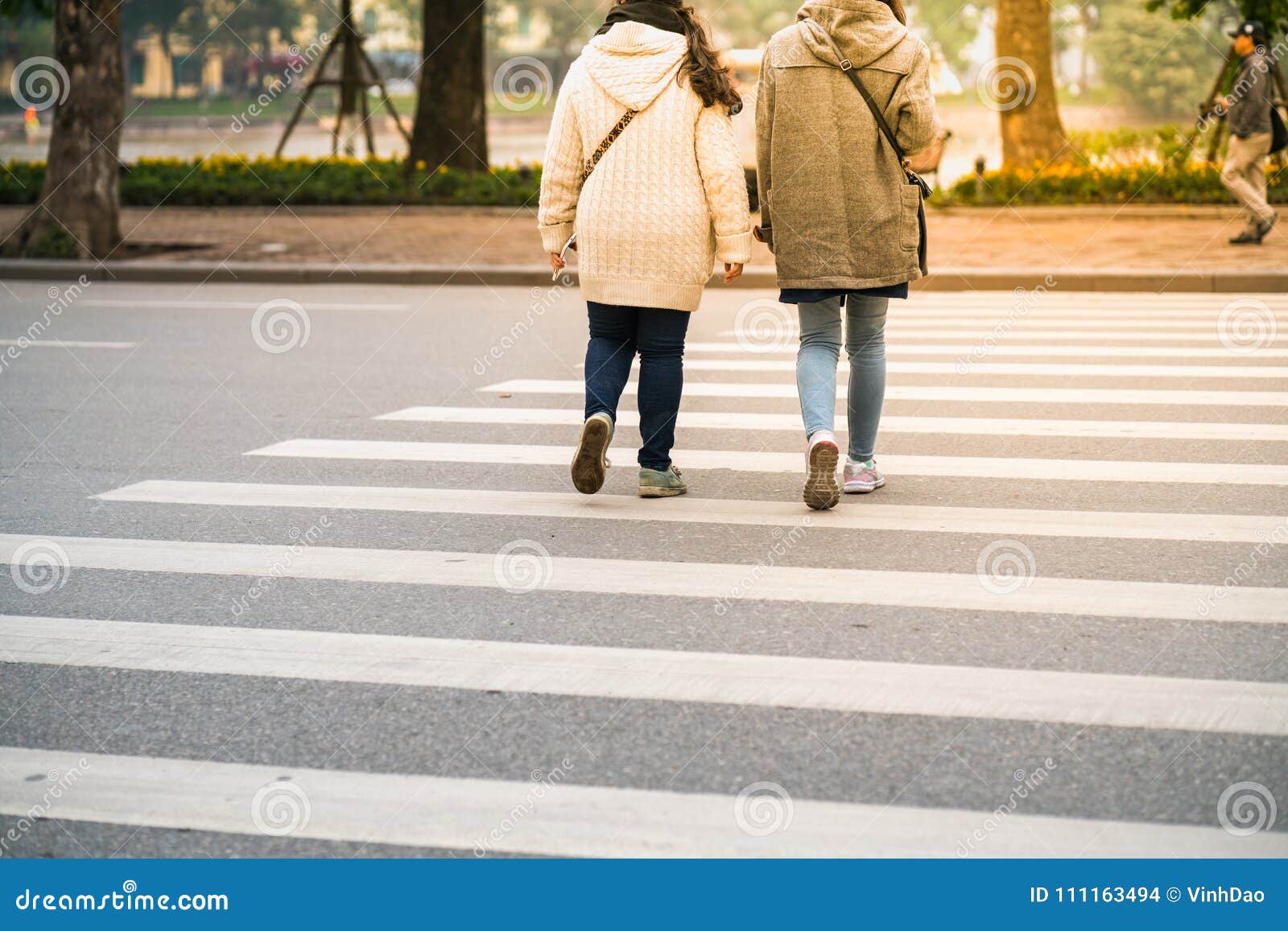 People Crossing Street In The Busy Streets Of Hanoi, Vietnam Stock