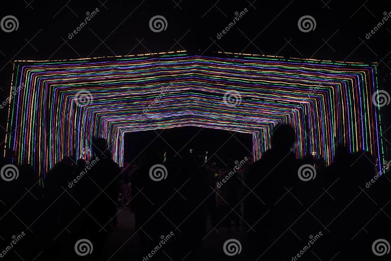 People Walking through Tunnel of Lights at the Christmas Fantasy of